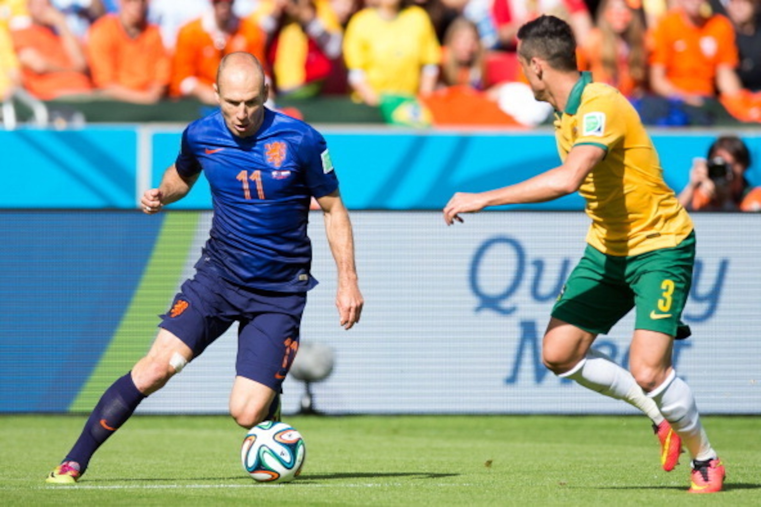 PORTO ALEGRE, BRAZIL - JUNE 18:  Arjen Robben of the Netherlands and Jason Davidson of Australia compete for the ball during the 2014 FIFA World Cup Brazil Group B match between Australia and Netherlands at Estadio Beira-Rio on June 18, 2014 in Porto Aleg