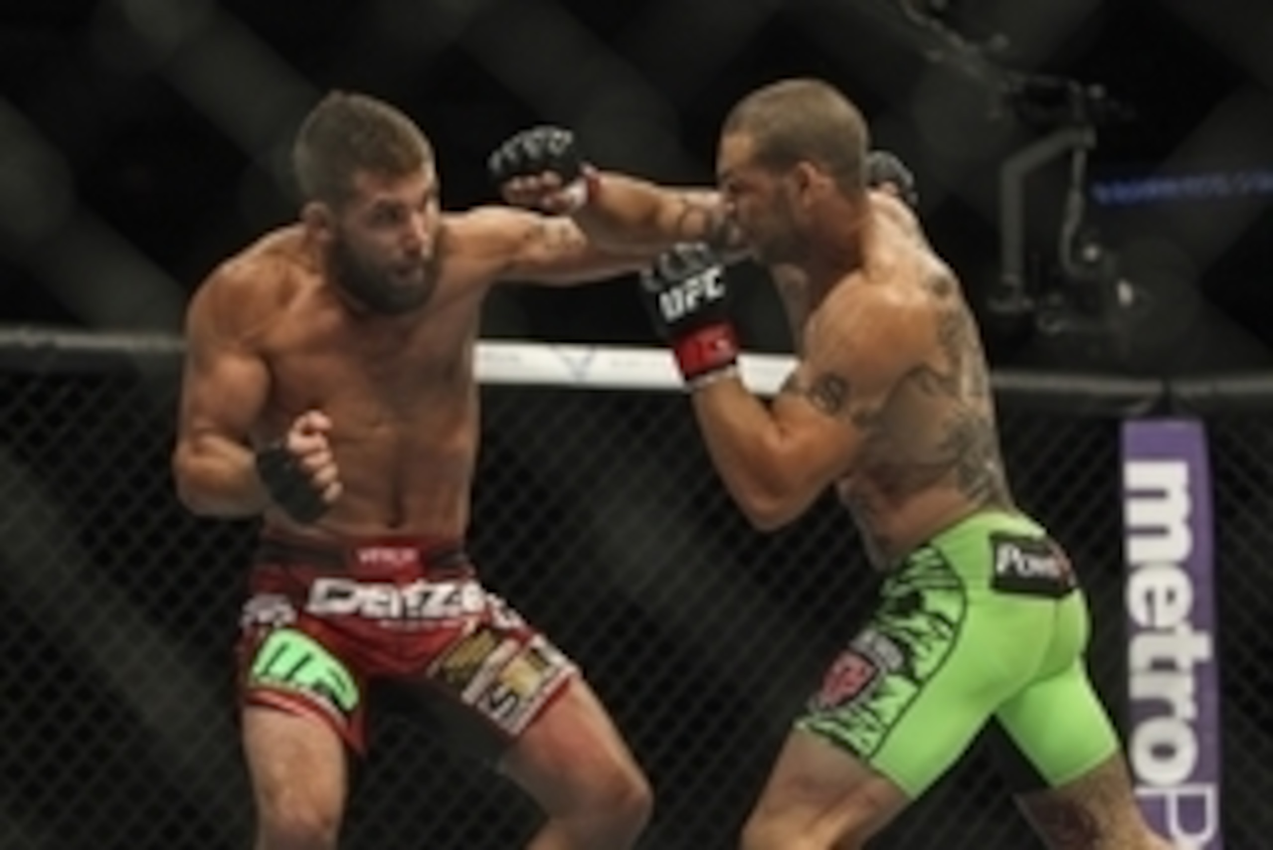 Jun 28, 2014; San Antonio, TX, USA; Cub Swanson (red gloves) fights Jeremy Stephens (blue gloves) in a Featherweight bout at UFC Fight Night 43 at AT&T Center. Mandatory Credit: Troy Taormina-USA TODAY Sports