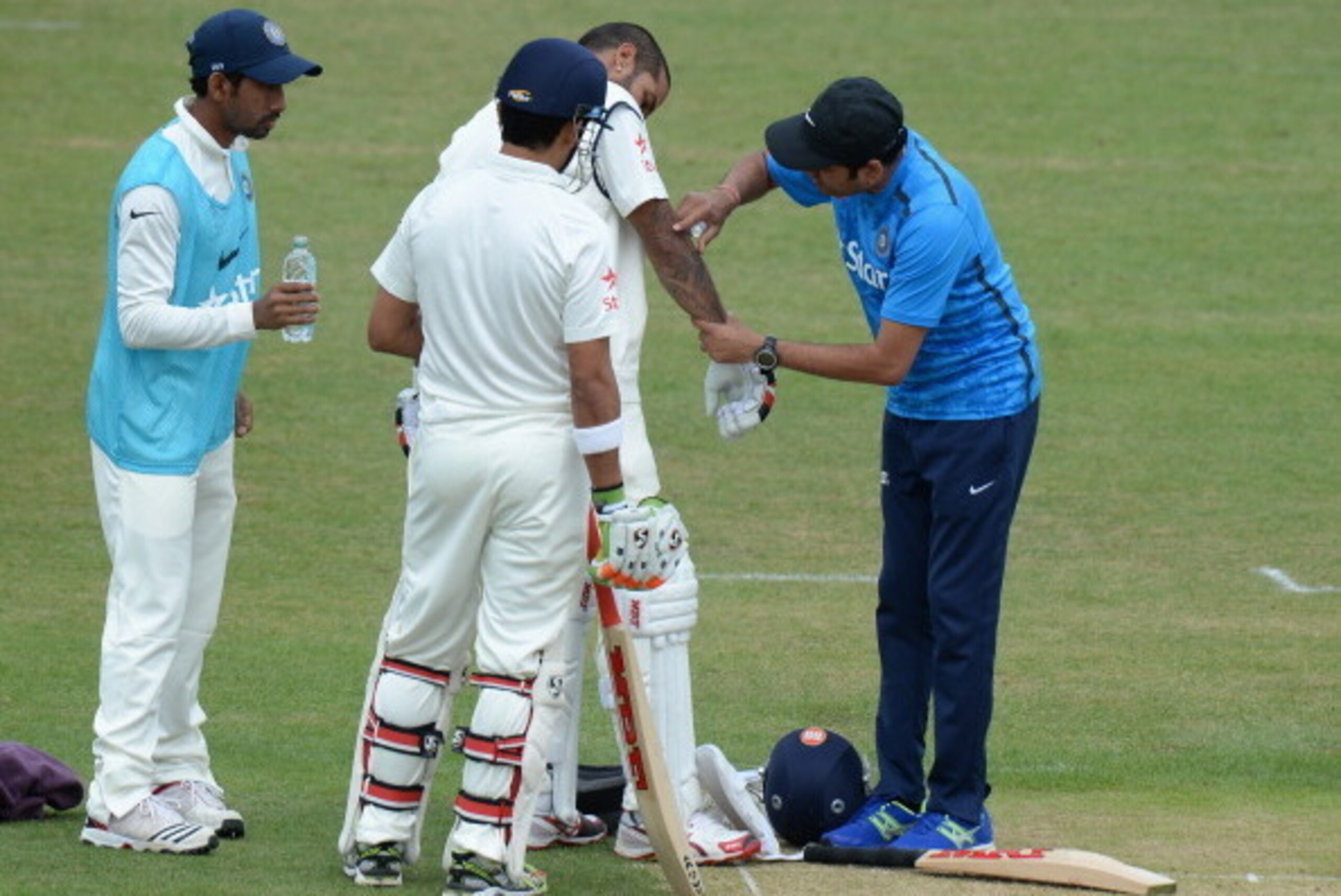 LEICESTER, ENGLAND - JUNE 26:  Shikhar Dhawan of India receives treatment after being hit on the arm from a delivery from Atif Sheikh of leicestershire during the Tour Match between Leicestershire and India at Grace Road on June 26, 2014 in Leicester, Eng