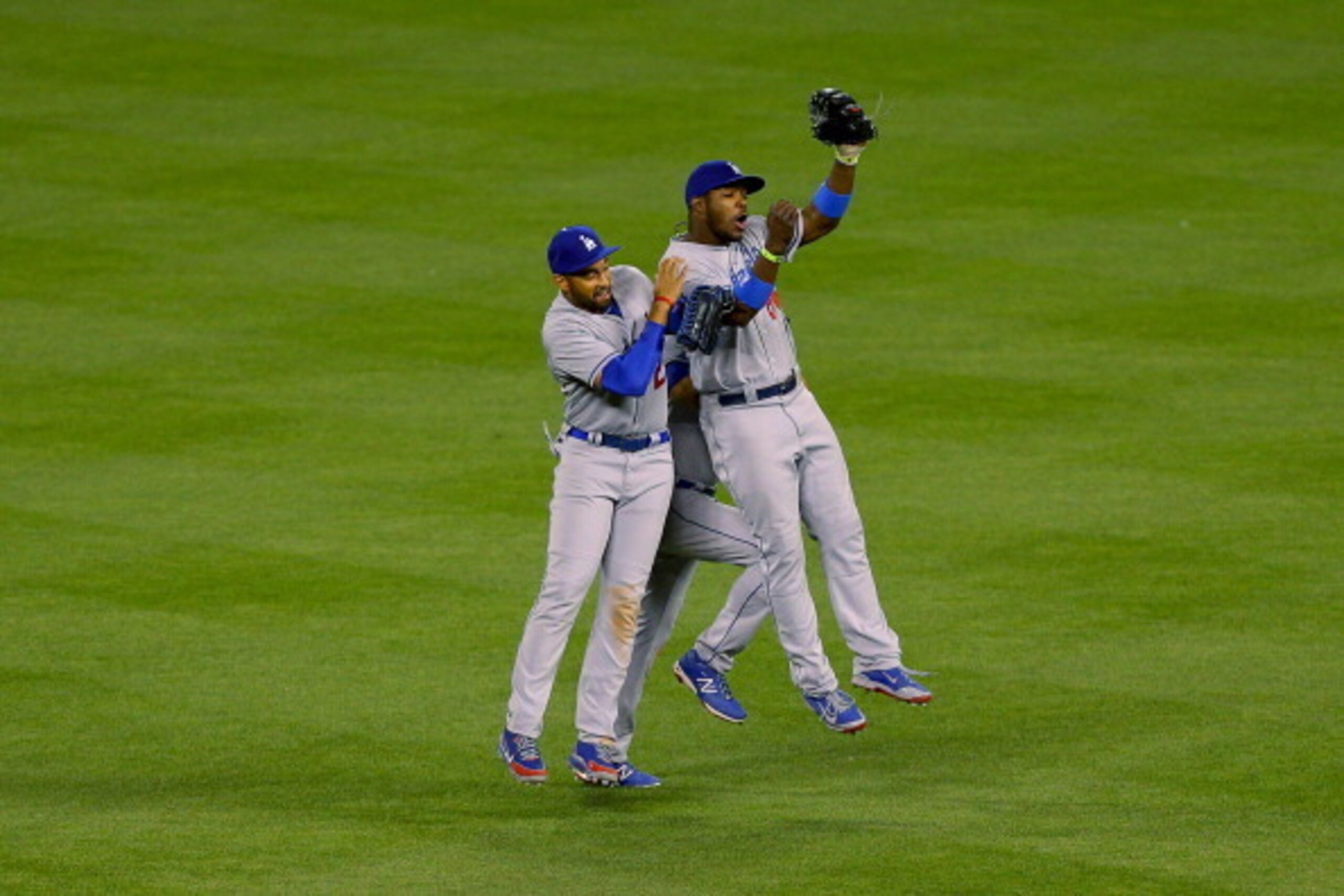DENVER, CO - JUNE 6:  Matt Kemp #27, Yasiel Puig #66 and Andre Ethier #16 of the Los Angeles Dodgers celebrate their 7-2 win against the Colorado Rockies at Coors Field on June 6, 2014 in Denver, Colorado. (Photo by Justin Edmonds/Getty Images)