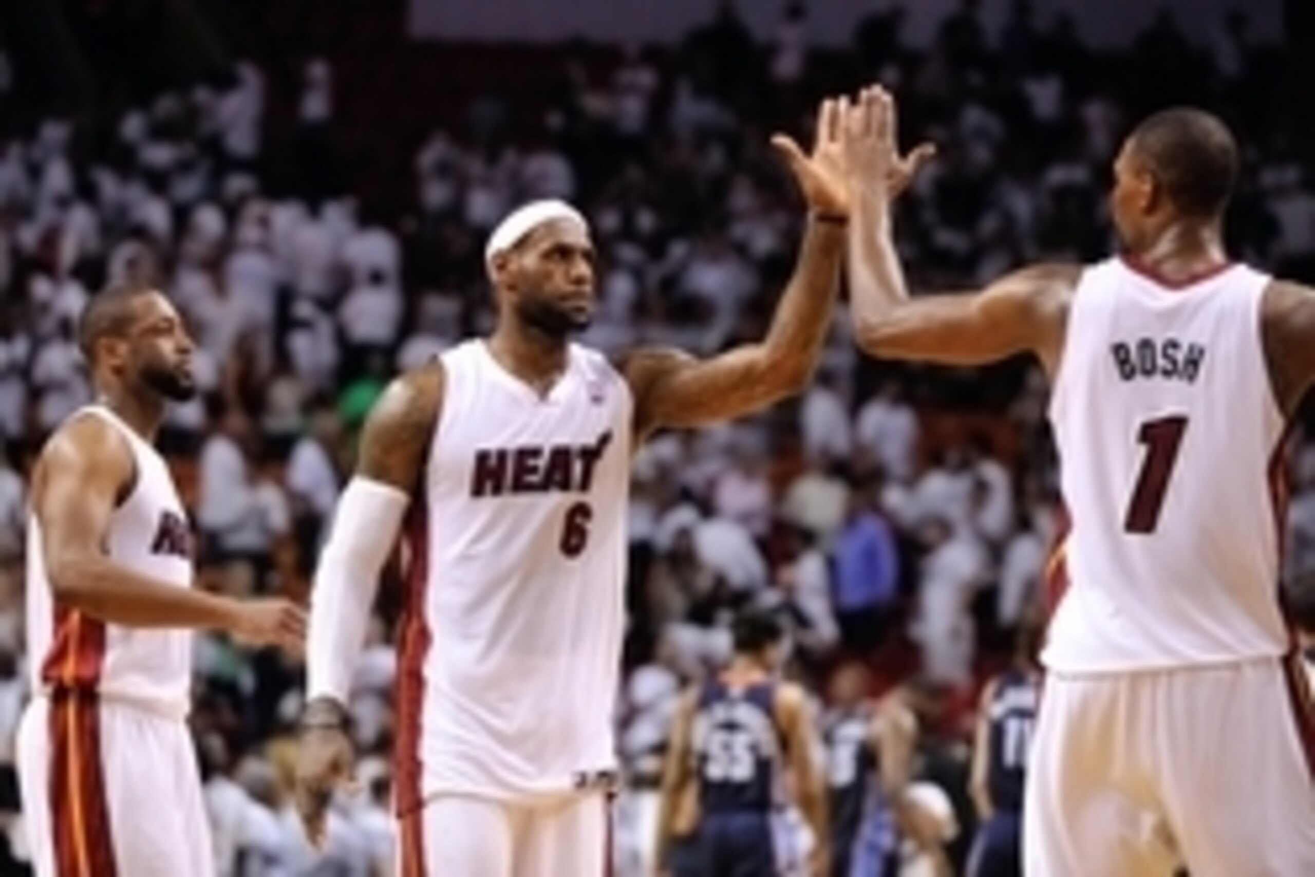 Apr 23, 2014; Miami, FL, USA; Miami Heat forward LeBron James (center) celebrates with center Chris Bosh (right) and guard Dwyane Wade (left) against the Charlotte Bobcats in game two during the first round of the 2014 NBA Playoffs at American Airlines Ar