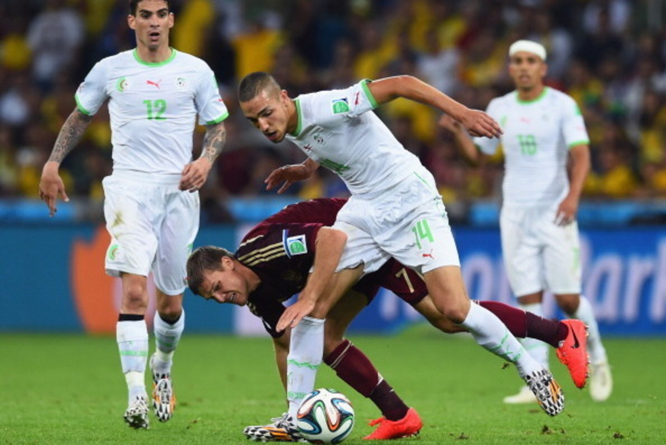 CURITIBA, BRAZIL - JUNE 26:  Igor Denisov of Russia challenges Nabil Bentaleb of Algeria during the 2014 FIFA World Cup Brazil Group H match between Algeria and Russia at Arena da Baixada on June 26, 2014 in Curitiba, Brazil.  (Photo by Matthias Hangst/Ge
