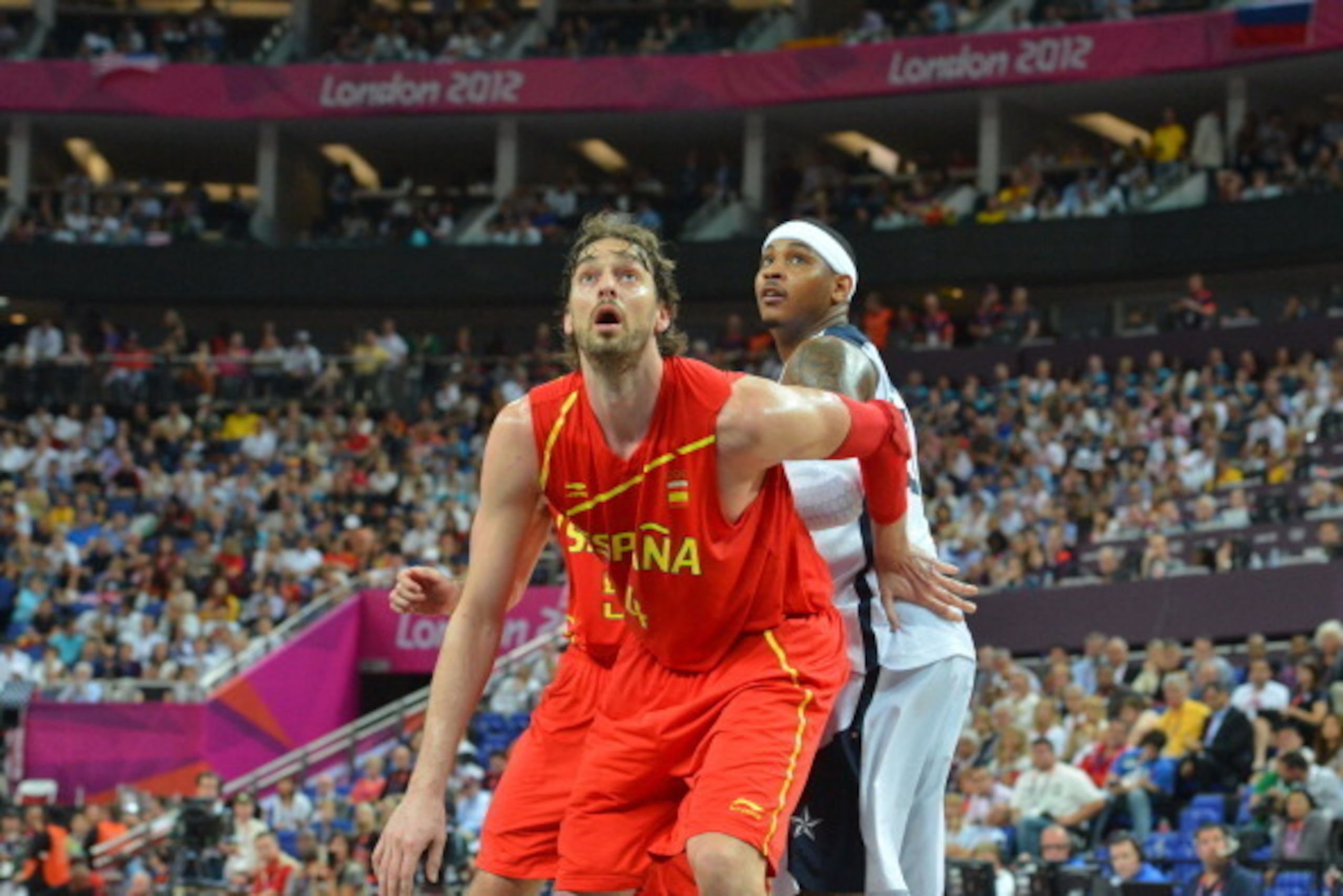 LONDON, ENGLAND - AUGUST 12: Pau Gasol #4 of Spain looks to rebound against Carmelo Anthony #15 of the US Men's Senior Nation Team during their Men's Gold Medal Basketball Game on Day 16 of the London 2012 Olympic Games at the North Greenwich Arena on Aug