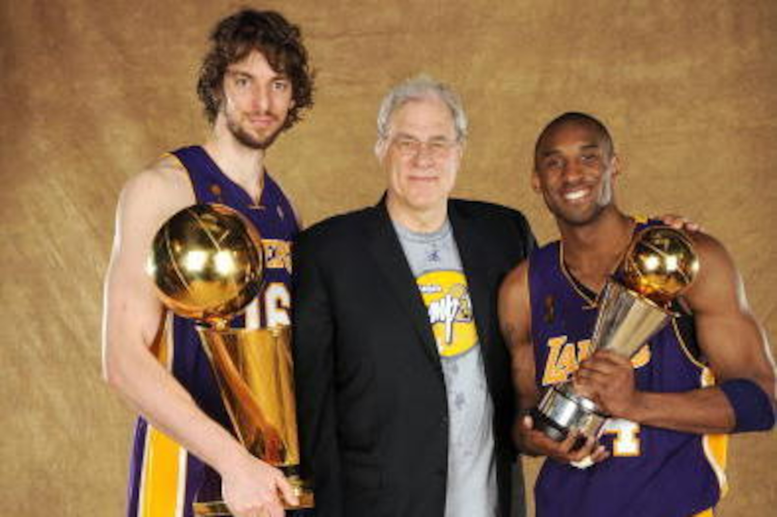 ORLANDO, FL - JUNE 14: Pau Gasol #16, Phil Jackson and Kobe Bryant #24 of the Los Angeles Lakers pose for a portrait after defeating the Orlando Magic in Game Five of the 2009 NBA Finals at Amway Arena on June 14, 2009 in Orlando, Florida. The Los Angeles