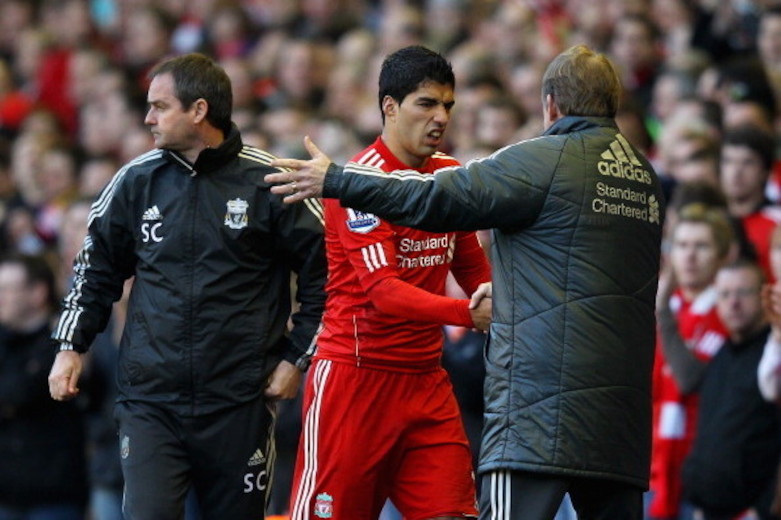 LIVERPOOL, ENGLAND - MARCH 18:  Luis Suarez of Liverpool shakes hands with Kenny Dalglish, manager of Liverpool as he leaves the field during the FA Cup with Budweiser Sixth Round match between Liverpool and Stoke City at Anfield on March 18, 2012 in Live