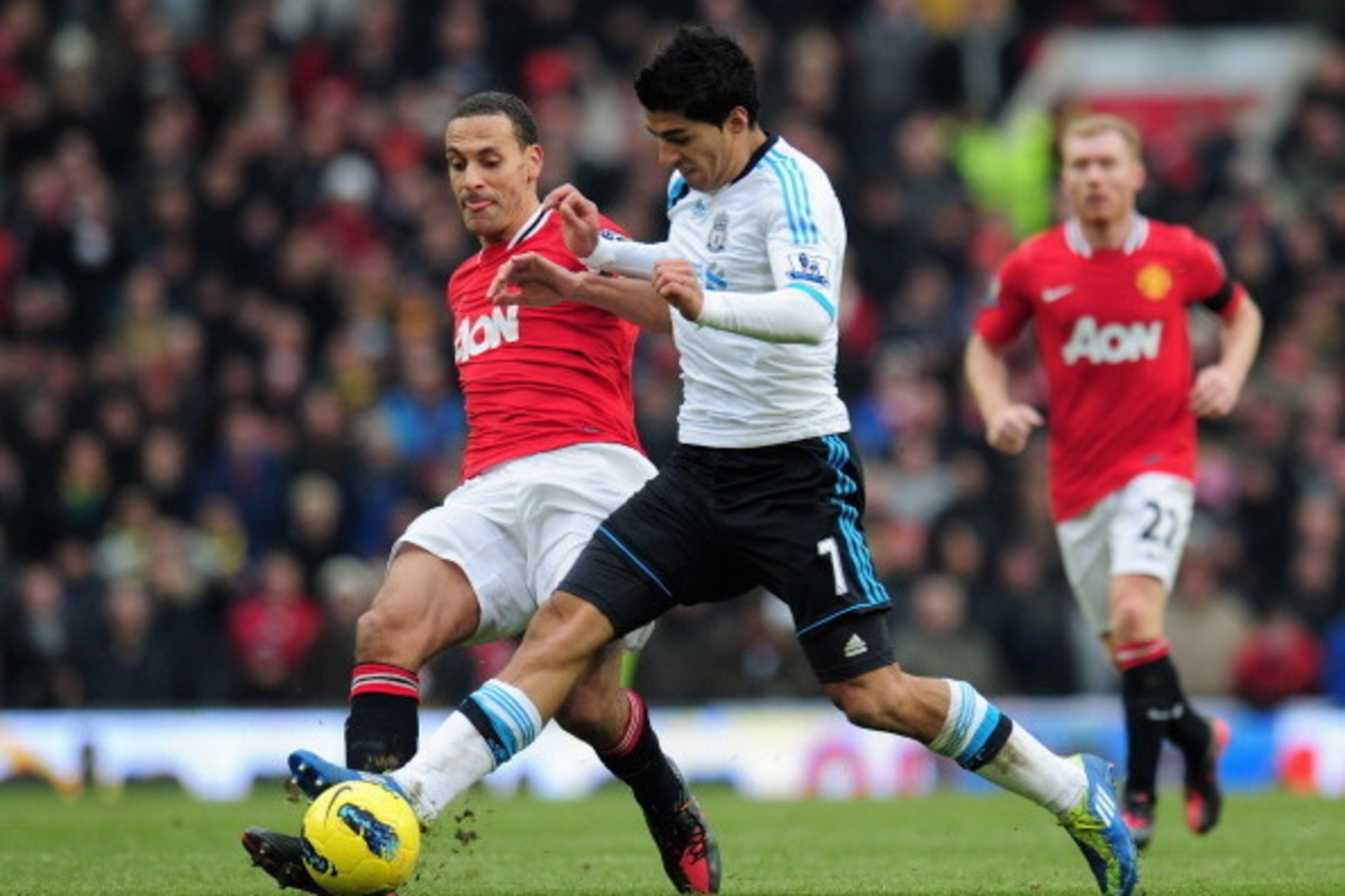 MANCHESTER, ENGLAND - FEBRUARY 11:  Luis Suarez of Liverpool is challenged by Rio Ferdinand of Manchester United during the Barclays Premier League match between Manchester United and Liverpool at Old Trafford on February 11, 2012 in Manchester, England. 