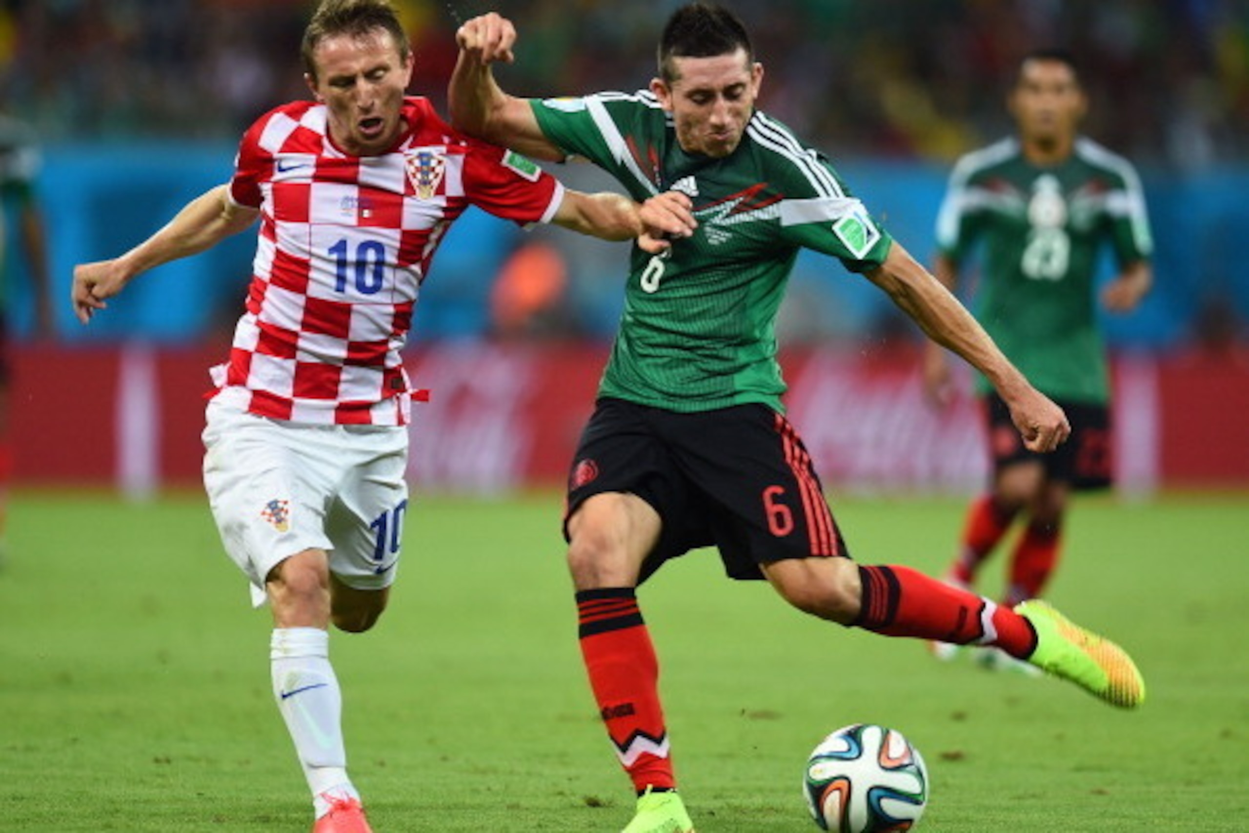RECIFE, BRAZIL - JUNE 23:  Luka Modric of Croatia and Hector Herrera of Mexico compete for the ball during the 2014 FIFA World Cup Brazil Group A match between Croatia and Mexico at Arena Pernambuco on June 23, 2014 in Recife, Brazil.  (Photo by Jamie McD
