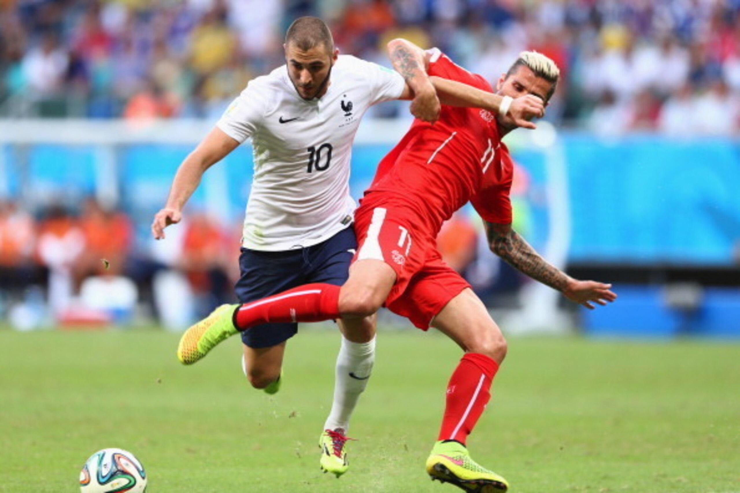 SALVADOR, BRAZIL - JUNE 20: Karim Benzema of France and Valon Behrami of Switzerland compete for the ball during the 2014 FIFA World Cup Brazil Group E match between Switzerland and France at Arena Fonte Nova on June 20, 2014 in Salvador, Brazil. (Photo SALVADOR, BRAZIL - JUNE 20: Karim Benzema of France and Valon Behrami of Switzerland compete for the ball during the 2014 FIFA World Cup Brazil Group E match between Switzerland and France at Arena Fonte Nova on June 20, 2014 in Salvador, Brazil. (Photo