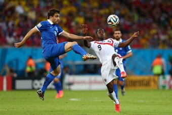 RECIFE, BRAZIL - JUNE 29:  Sokratis Papastathopoulos of Greece challenges Joel Campbell of Costa Rica during the 2014 FIFA World Cup Brazil Round of 16 match between Costa Rica and Greece at Arena Pernambuco on June 29, 2014 in Recife, Brazil.  (Photo by 