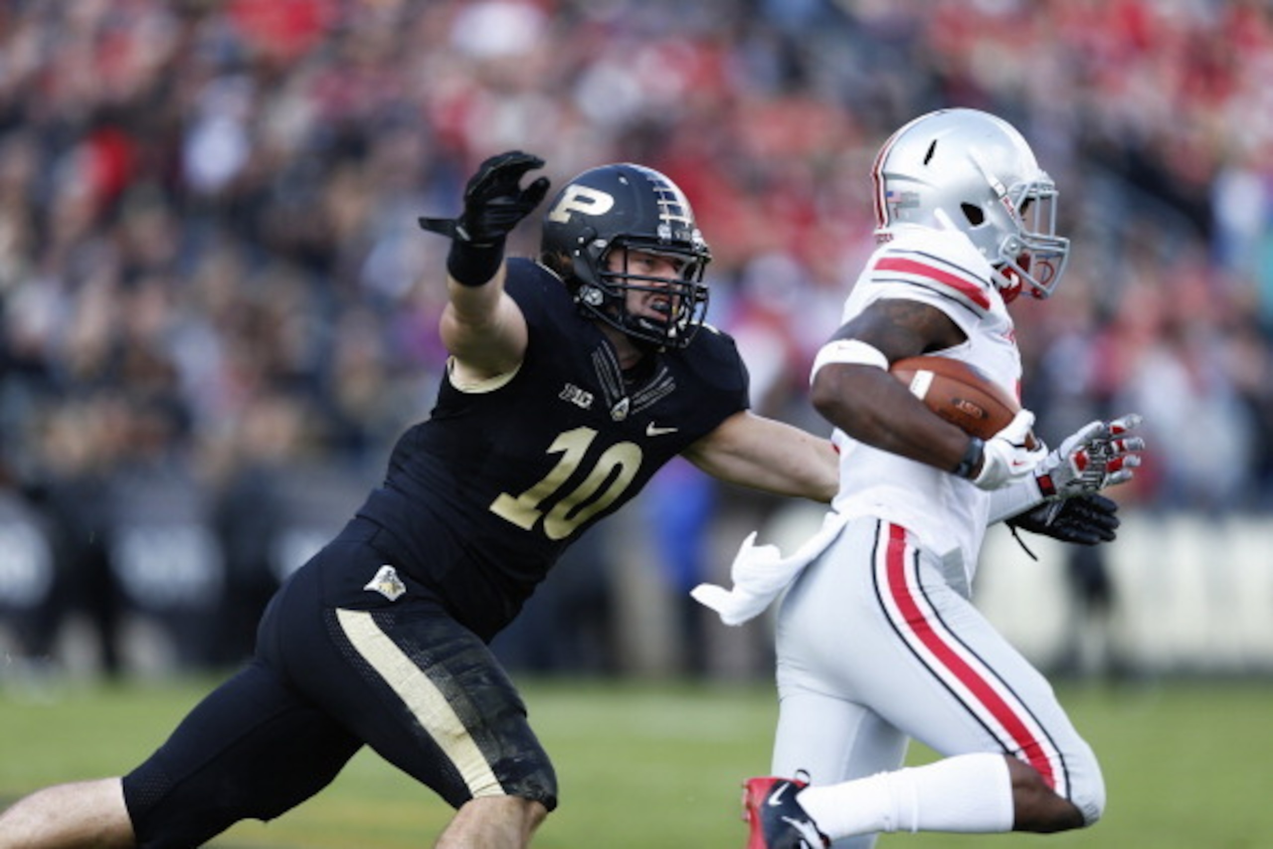 WEST LAFAYETTE, IN - NOVEMBER 2: Sean Robinson #10 of the Purdue Boilermakers tries to make a tackle against Dontre Wilson #1 of the Ohio State Buckeyes during the first half of the game at Ross-Ade Stadium on November 2, 2013 in West Lafayette, Indiana. 