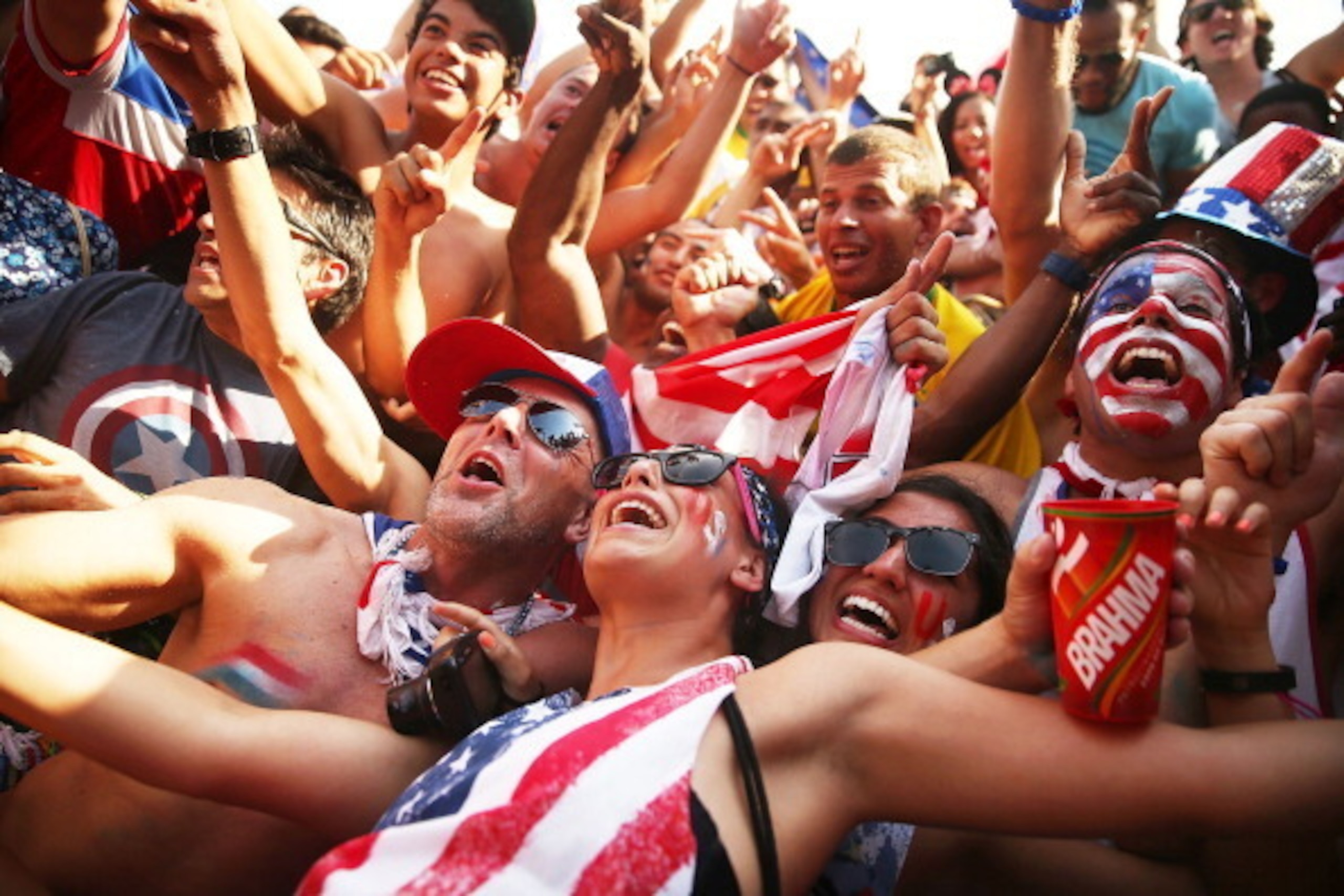 RIO DE JANEIRO, BRAZIL - JUNE 26:  U.S. supporters celebrate advancing to the Round of 16 after their loss to Germany while watching the match at FIFA Fan Fest on June 26, 2014 in Rio de Janeiro, Brazil. The U.S. lost 1-0 but still advance to the knockout