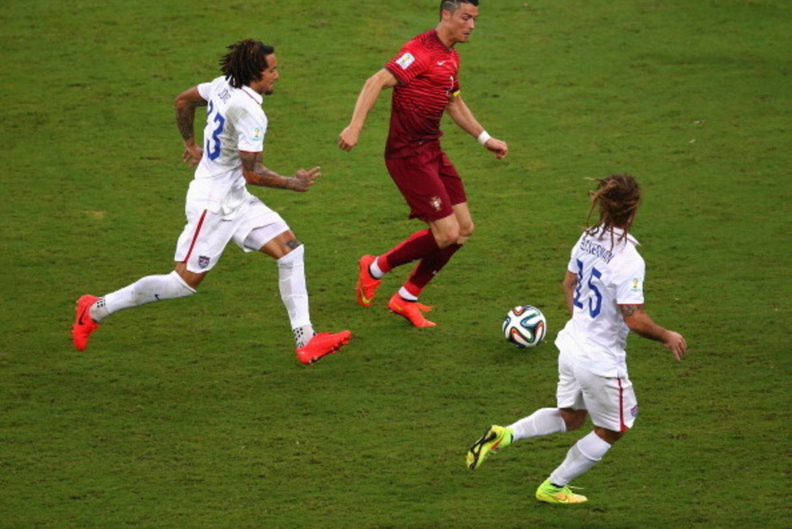 MANAUS, BRAZIL - JUNE 22: Cristiano Ronaldo of Portugal controls the ball against Jermaine Jones (L) and Kyle Beckerman of the United States during the 2014 FIFA World Cup Brazil Group G match between the United States and Portugal at Arena Amazonia on Ju