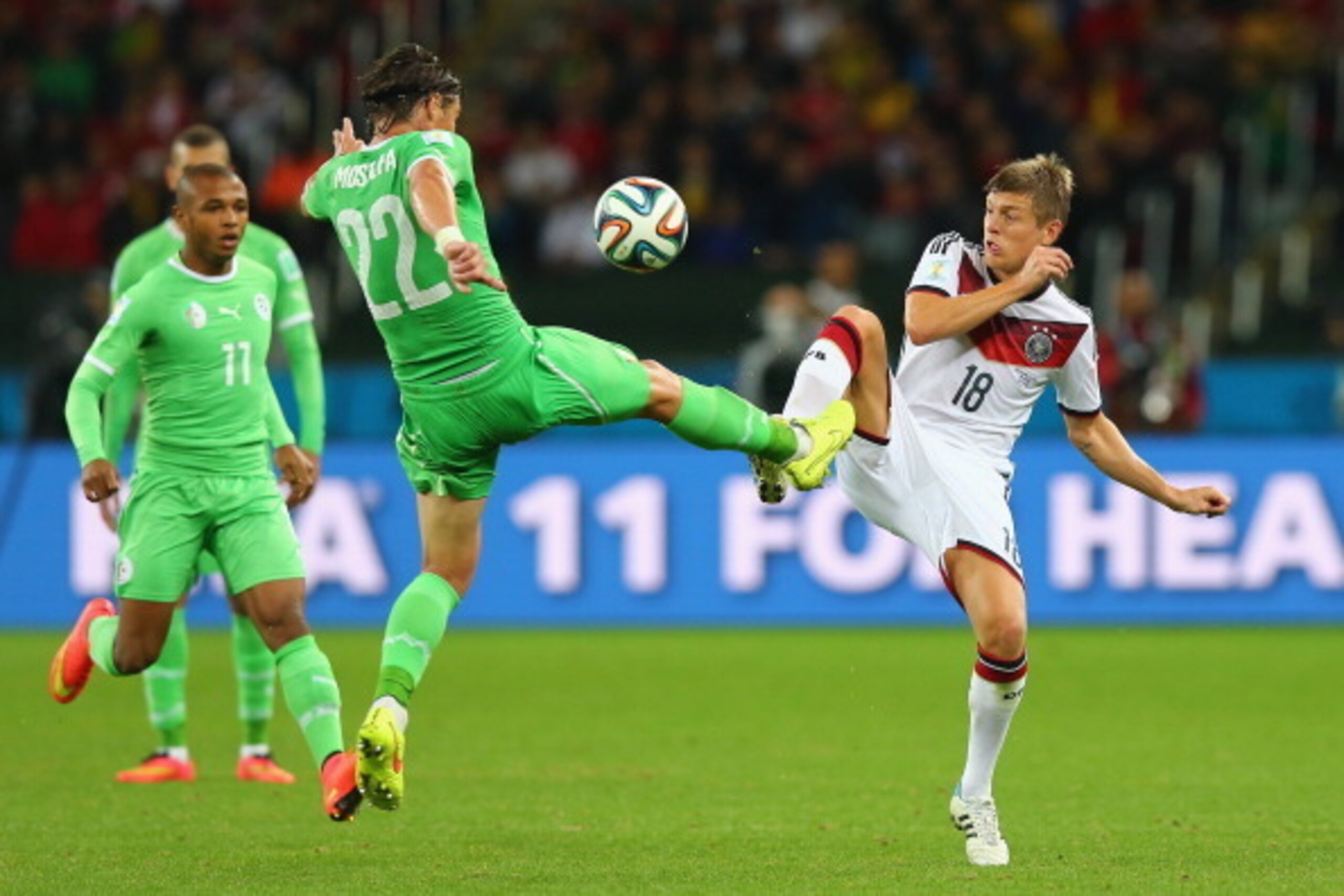PORTO ALEGRE, BRAZIL - JUNE 30: Mehdi Mostefa of Algeria and Toni Kroos of Germany compete for the ball during the 2014 FIFA World Cup Brazil Round of 16 match between Germany and Algeria at Estadio Beira-Rio on June 30, 2014 in Porto Alegre, Brazil. (Ph PORTO ALEGRE, BRAZIL - JUNE 30: Mehdi Mostefa of Algeria and Toni Kroos of Germany compete for the ball during the 2014 FIFA World Cup Brazil Round of 16 match between Germany and Algeria at Estadio Beira-Rio on June 30, 2014 in Porto Alegre, Brazil. (Ph