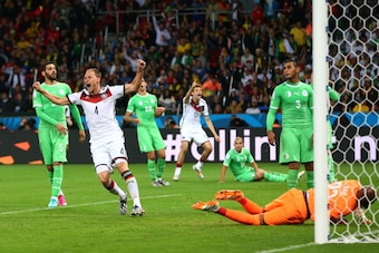 PORTO ALEGRE, BRAZIL - JUNE 30: Benedikt Hoewedes of Germany celebrates his team's first goal by Andre Schuerrle (not pictured) past Rais M'Bolhi of Algeria in extra time during the 2014 FIFA World Cup Brazil Round of 16 match between Germany and Algeria 