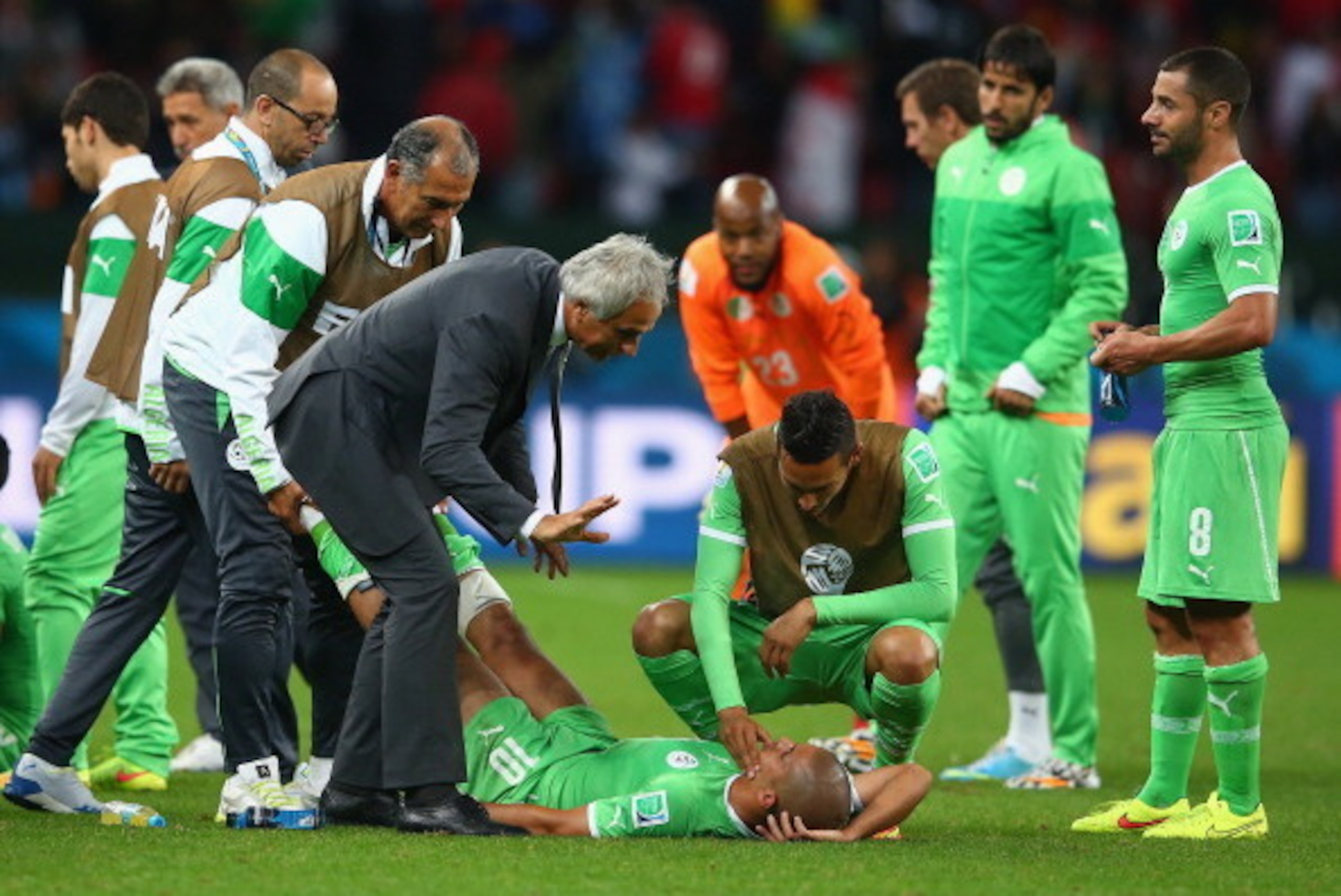PORTO ALEGRE, BRAZIL - JUNE 30:  Head coach Vahid Halilhodzic of Algeria speaks to Sofiane Feghouli as he lies on the ground prior to the start of extra time during the 2014 FIFA World Cup Brazil Round of 16 match between Germany and Algeria at Estadio Be