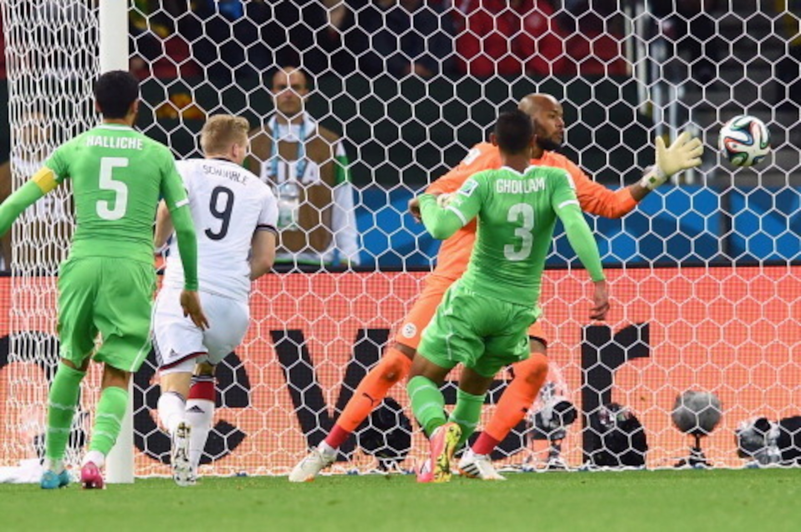 PORTO ALEGRE, BRAZIL - JUNE 30:  Andre Schuerrle of Germany scores his team's first goal past goalkeeper Rais M'Bolhi of Algeria in extra time during the 2014 FIFA World Cup Brazil Round of 16 match between Germany and Algeria at Estadio Beira-Rio on June