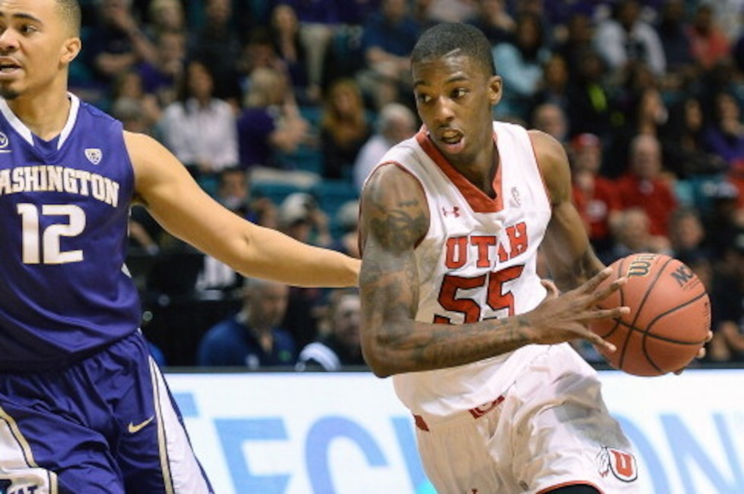 LAS VEGAS, NV - MARCH 12:  Delon Wright #55 of the Utah Utes drives against Andrew Andrews #12 of the Washington Huskies during a first-round game of the Pac-12 Basketball Tournament at the MGM Grand Garden Arena on March 12, 2014 in Las Vegas, Nevada. Ut