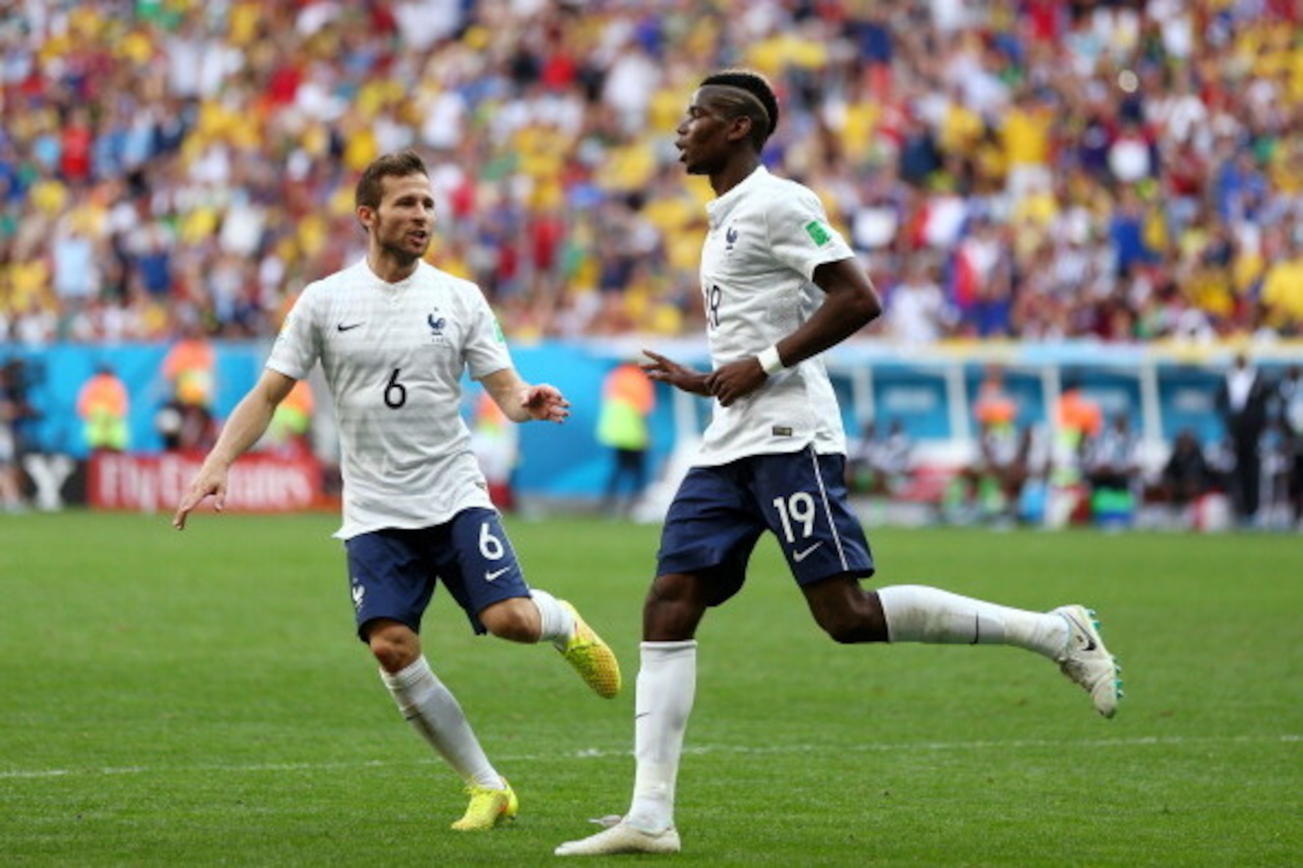 BRASILIA, BRAZIL - JUNE 30:  Paul Pogba of France (R) celebrates scoring his team's first goal with Yohan Cabaye during the 2014 FIFA World Cup Brazil Round of 16 match between France and Nigeria at Estadio Nacional on June 30, 2014 in Brasilia, Brazil.  
