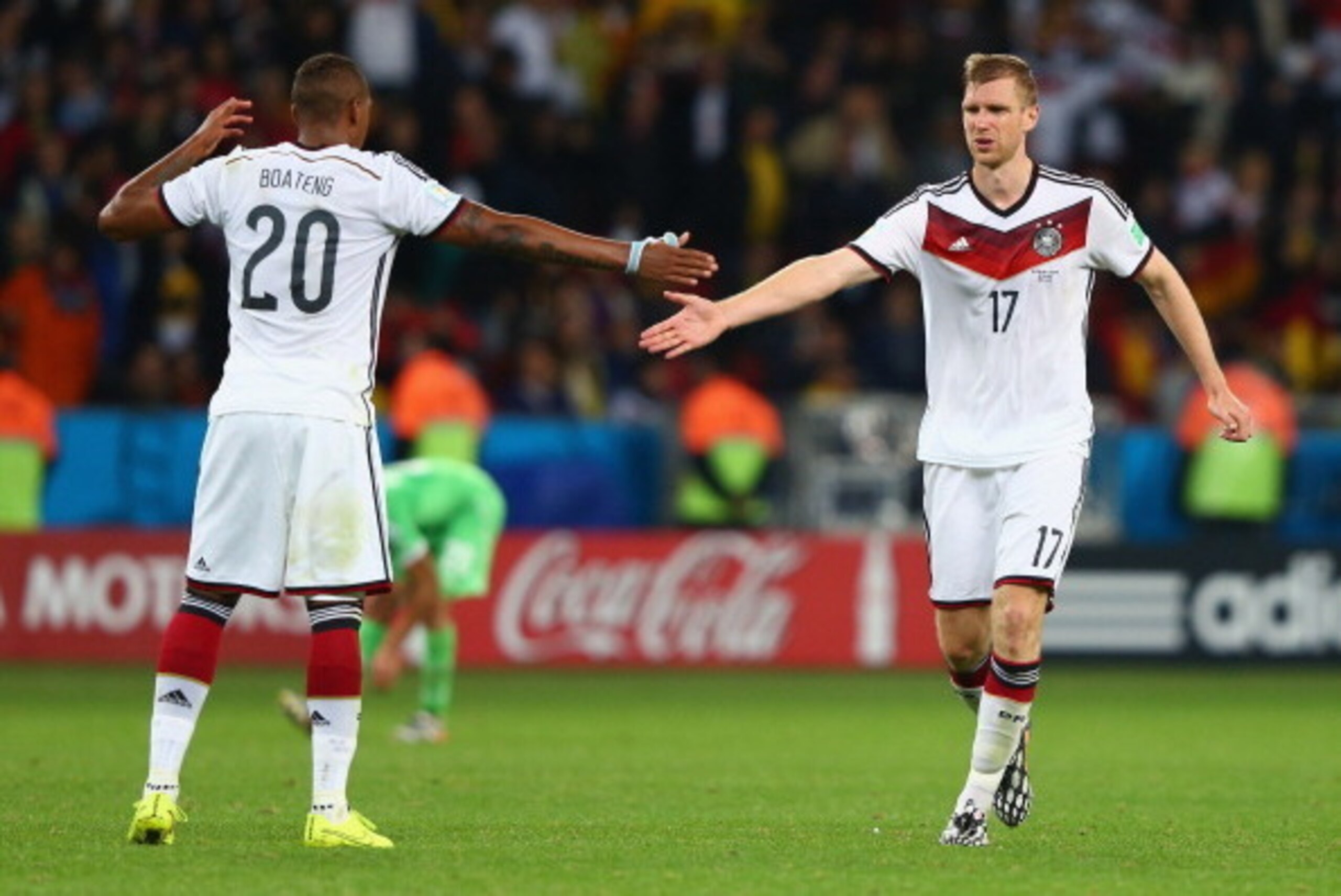 PORTO ALEGRE, BRAZIL - JUNE 30:  Jerome Boateng and Per Mertesacker of Germany celebrate their team's second goal in extra time during the 2014 FIFA World Cup Brazil Round of 16 match between Germany and Algeria at Estadio Beira-Rio on June 30, 2014 in Po