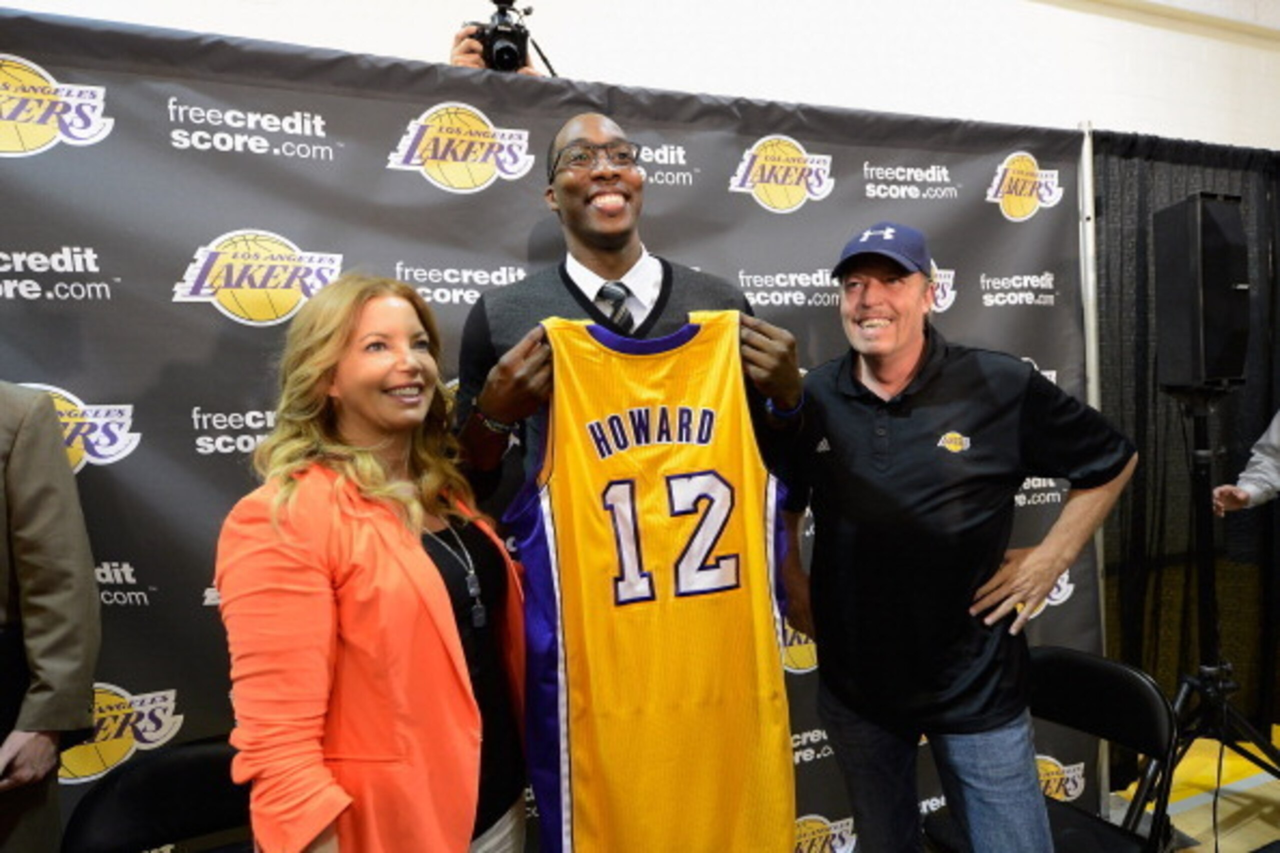 EL SEGUNDO, CA - AUGUST 10:  Jim Buss and his sister Jeanie Buss of the Los Angeles Lakers pose with the newest member of the Lakers Dwight Howard at the Toyota Sports Center on August 10, 2012 in El Segundo, California. The Lakers acquired Howard from Or