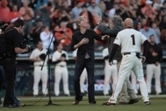 Oct 15, 2012; San Francisco, CA, USA; Grateful Dead band members Phil Lesh (left) and Bob Weir (center) perform the national anthem with San Francisco Giants third base coach Tim Flannery (1) before game two of the 2012 NLCS against the St. Louis Cardinal