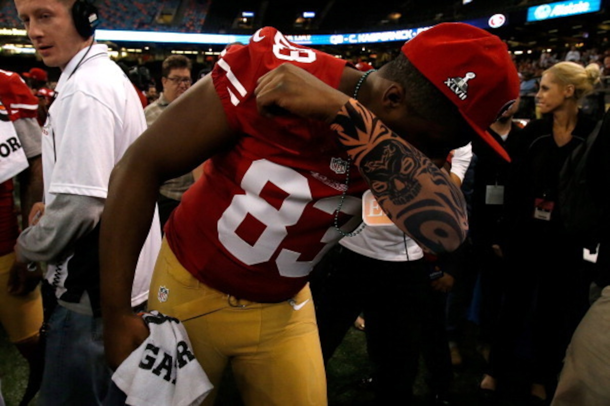 NEW ORLEANS, LA - JANUARY 29:  Demarcus Dobbs #83 of the San Francisco 49ers kisses his bicep as he answers questions from the media during Super Bowl XLVII Media Day ahead of Super Bowl XLVII at the Mercedes-Benz Superdome on January 29, 2013 in New Orle