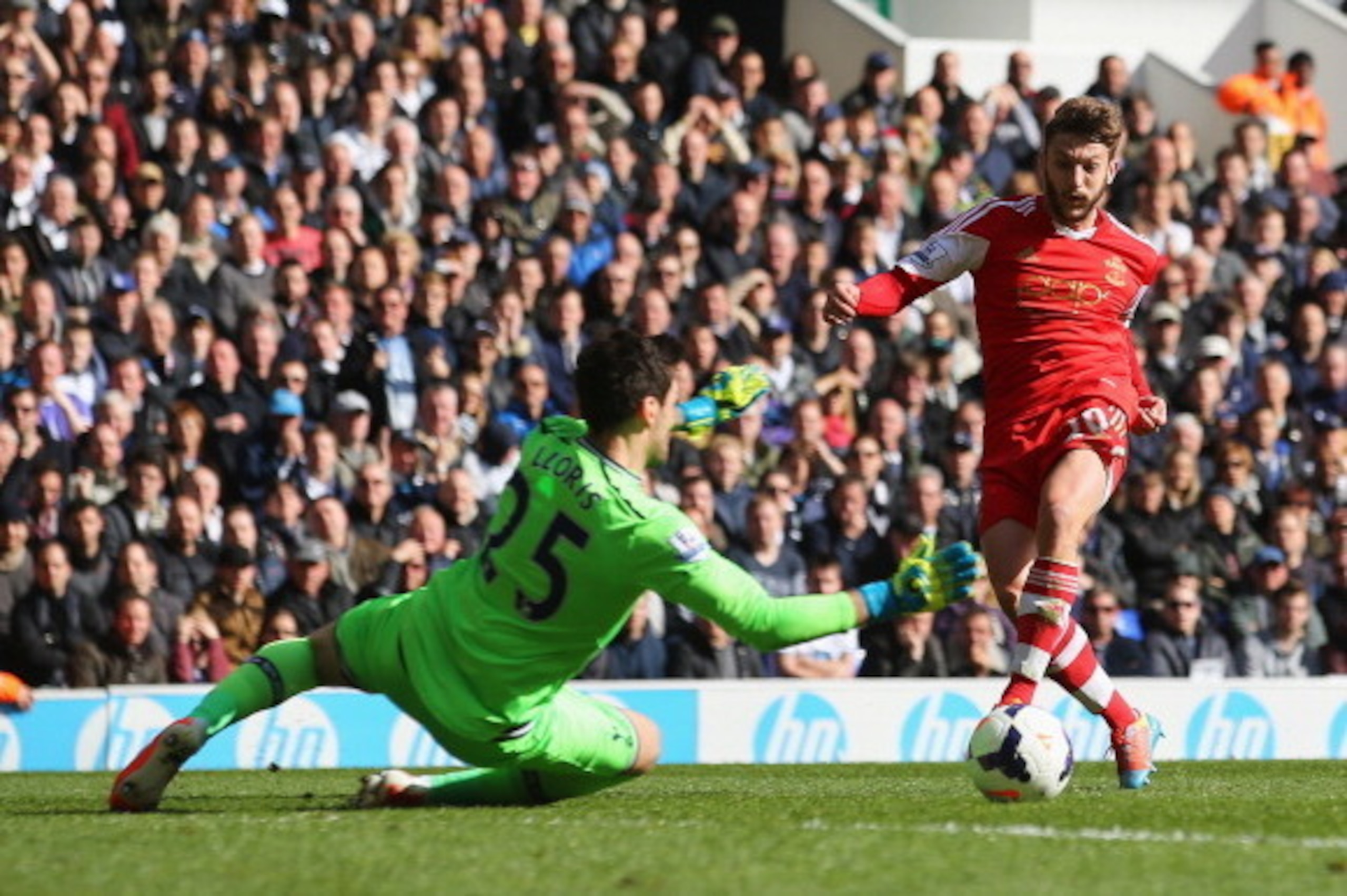 LONDON, ENGLAND - MARCH 23:  Adam Lallana of Southampton scores his team's second goal past Hugo Lloris of Tottenham Hotspur during the Barclays Premier League match between Tottenham Hotspur and Southampton at White Hart Lane on March 23, 2014 in London,