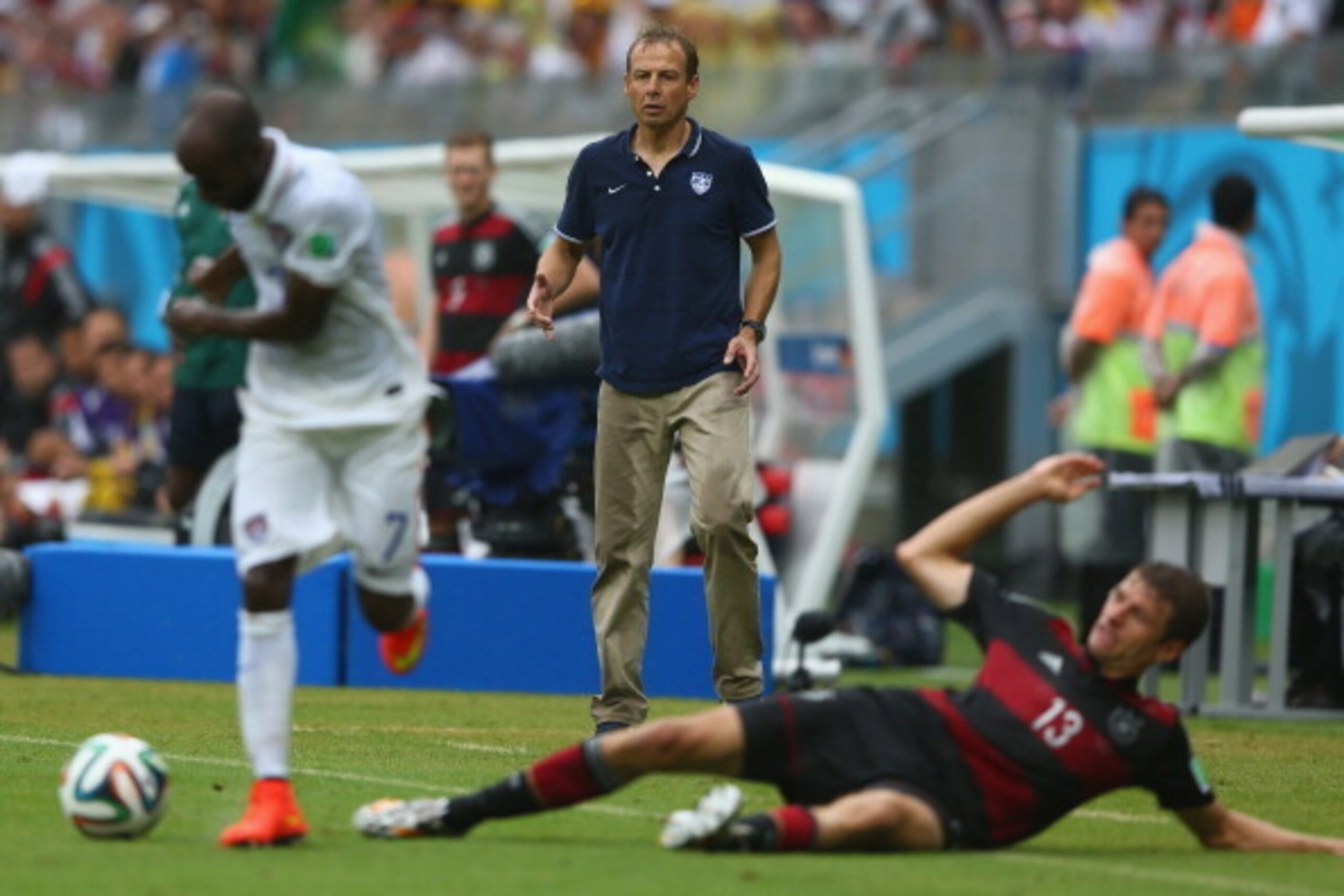 RECIFE, BRAZIL - JUNE 26: Head coach Jurgen Klinsmann of United States looks on as Thomas Mueller (R) of Germany loses out to DaMarcus Beasley of the United States during the 2014 FIFA World Cup Brazil Group G match between USA and Germany at Arena Perna RECIFE, BRAZIL - JUNE 26: Head coach Jurgen Klinsmann of United States looks on as Thomas Mueller (R) of Germany loses out to DaMarcus Beasley of the United States during the 2014 FIFA World Cup Brazil Group G match between USA and Germany at Arena Perna