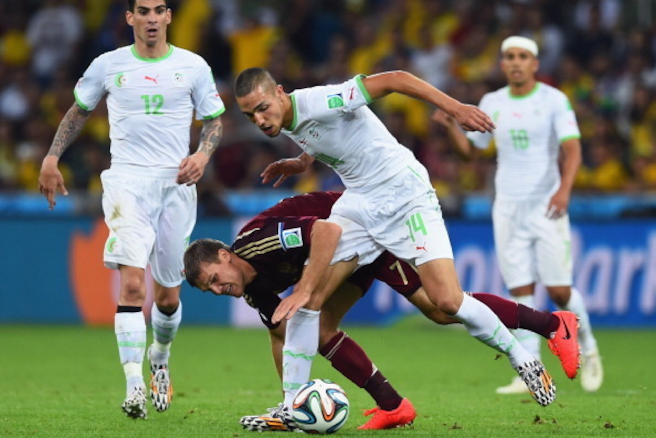 CURITIBA, BRAZIL - JUNE 26:  Igor Denisov of Russia challenges Nabil Bentaleb of Algeria during the 2014 FIFA World Cup Brazil Group H match between Algeria and Russia at Arena da Baixada on June 26, 2014 in Curitiba, Brazil.  (Photo by Matthias Hangst/Ge