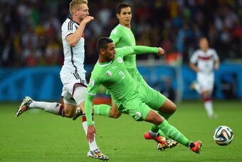 PORTO ALEGRE, BRAZIL - JUNE 30:  Faouzi Ghoulam of Algeria challenges Andre Schuerrle of Germany during the 2014 FIFA World Cup Brazil Round of 16 match between Germany and Algeria at Estadio Beira-Rio on June 30, 2014 in Porto Alegre, Brazil.  (Photo by 