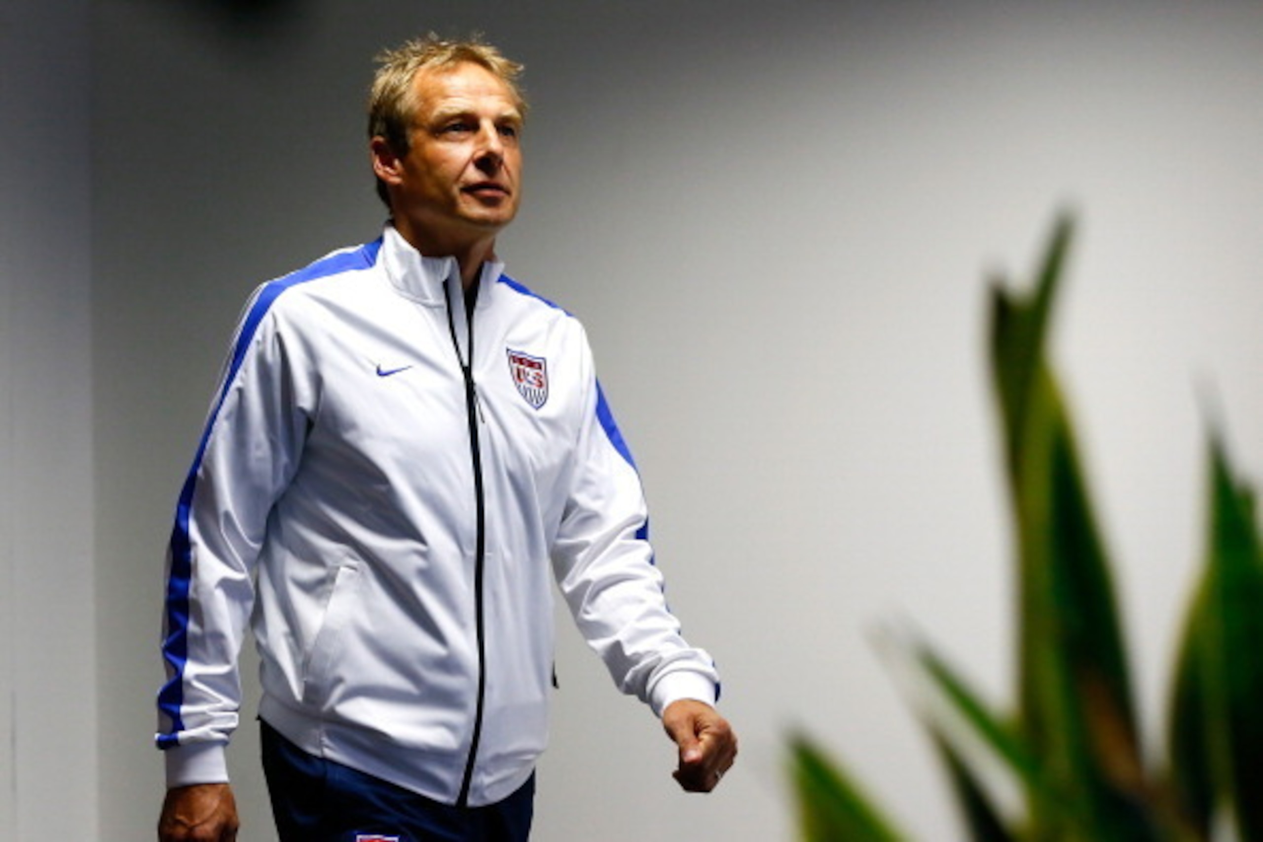 SALVADOR, BRAZIL - JUNE 30:  Head coach Jurgen Klinsmann of the United States enters the room to speak to the media during a press conference at Arena Fonte Nova on June 30, 2014 in Salvador, Brazil.  (Photo by Kevin C. Cox/Getty Images)