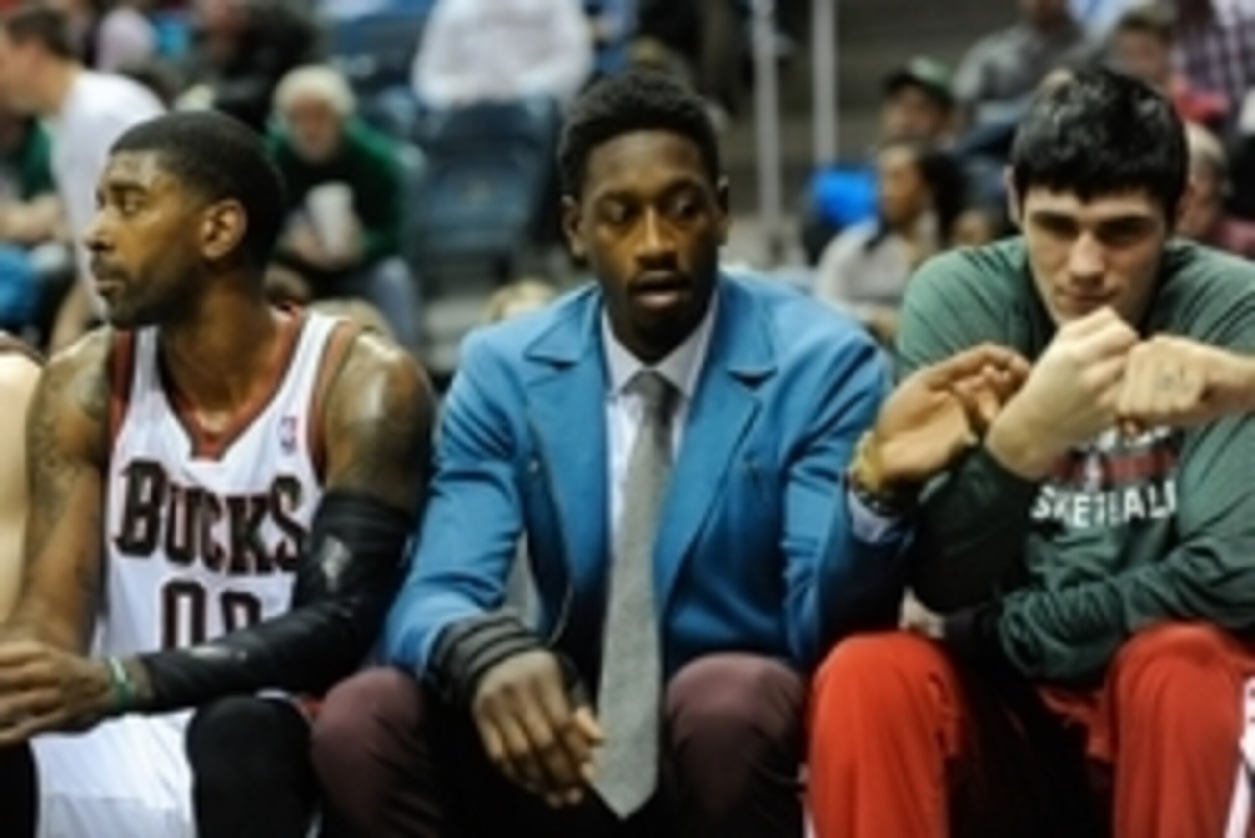 Nov 9, 2013; Milwaukee, WI, USA;  Milwaukee Bucks center Larry Sanders (center) sits on the bench with guard O.J. Mayo (left) and forward Ersan Ilyasova (right) in the 2nd quarter at BMO Harris Bradley Center. Sanders did not play after suffering a hand i