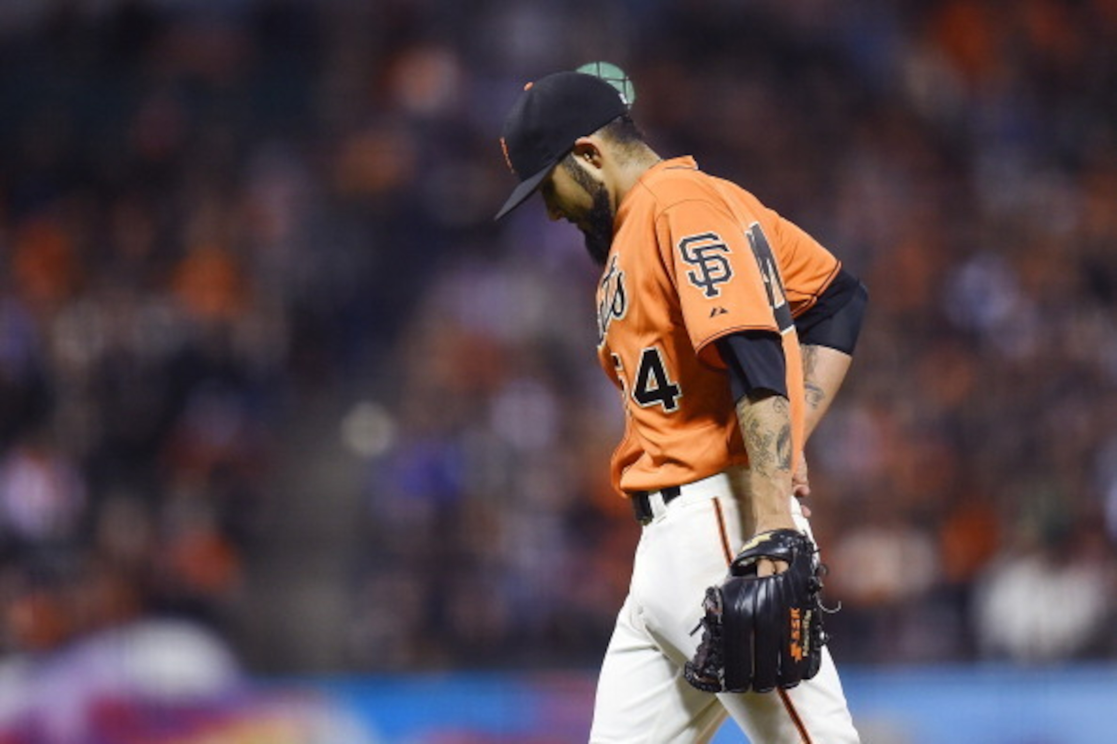 SAN FRANCISCO, CA - JUNE 13:  Sergio Romo #54 of the San Francisco Giants walks back towards the dugout after he was taken out of the game in the top of the ninth inning against the Colorado Rockies at AT&T Park on June 13, 2014 in San Francisco, Californ