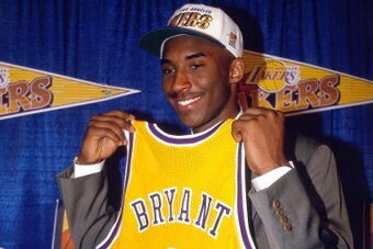 INGLEWOOD, CA - JULY 11:  Kobe Bryant holds a #8 Los Angeles Lakers jersey after being the 13th overall pick in the 1996 NBA Draft by the Charlotte Hornets who then traded his draft rights to the Los Angels Lakers on July 11, 1996 in Inglewood, California