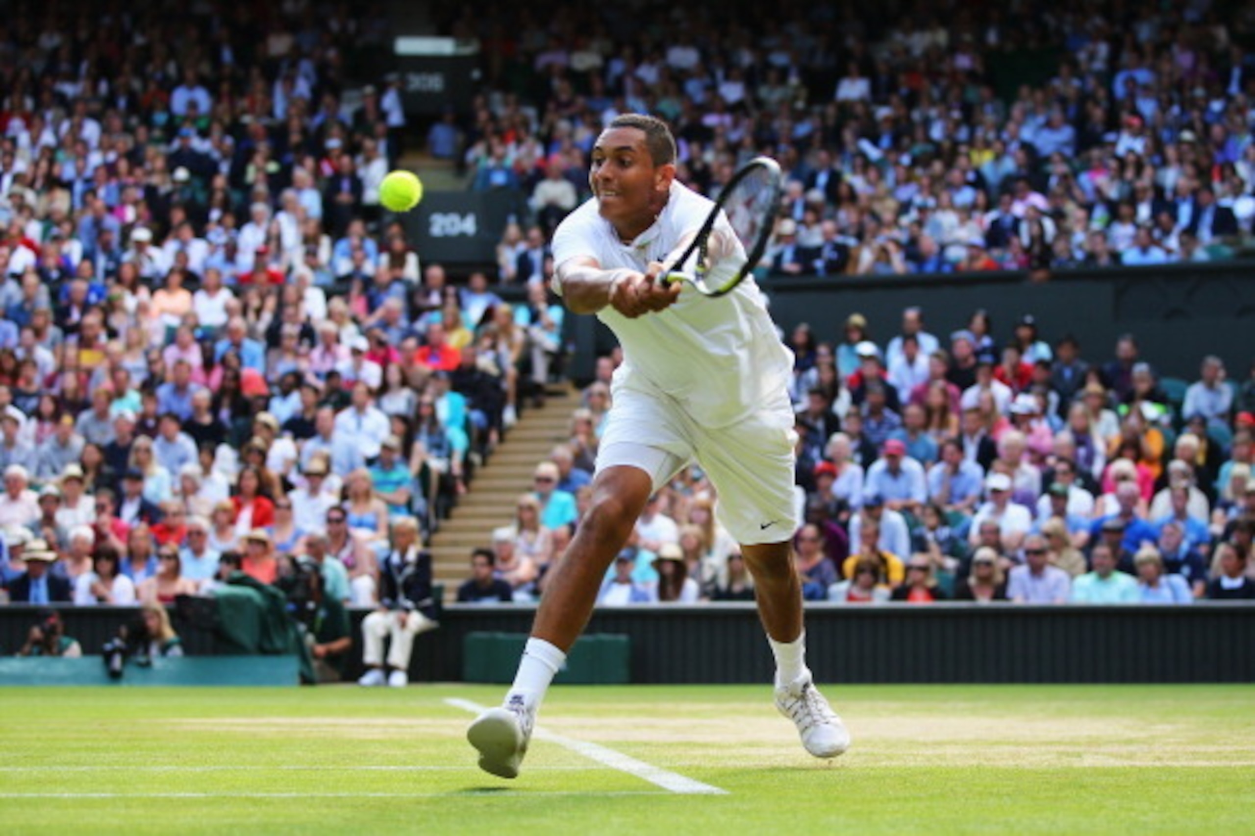 LONDON, ENGLAND - JULY 01:  Nick Kyrgios of Australia plays a backhand return during his Gentlemen's Singles fourth round match against Rafael Nadal of Spain on day eight of the Wimbledon Lawn Tennis Championships at the All England Lawn Tennis and Croque