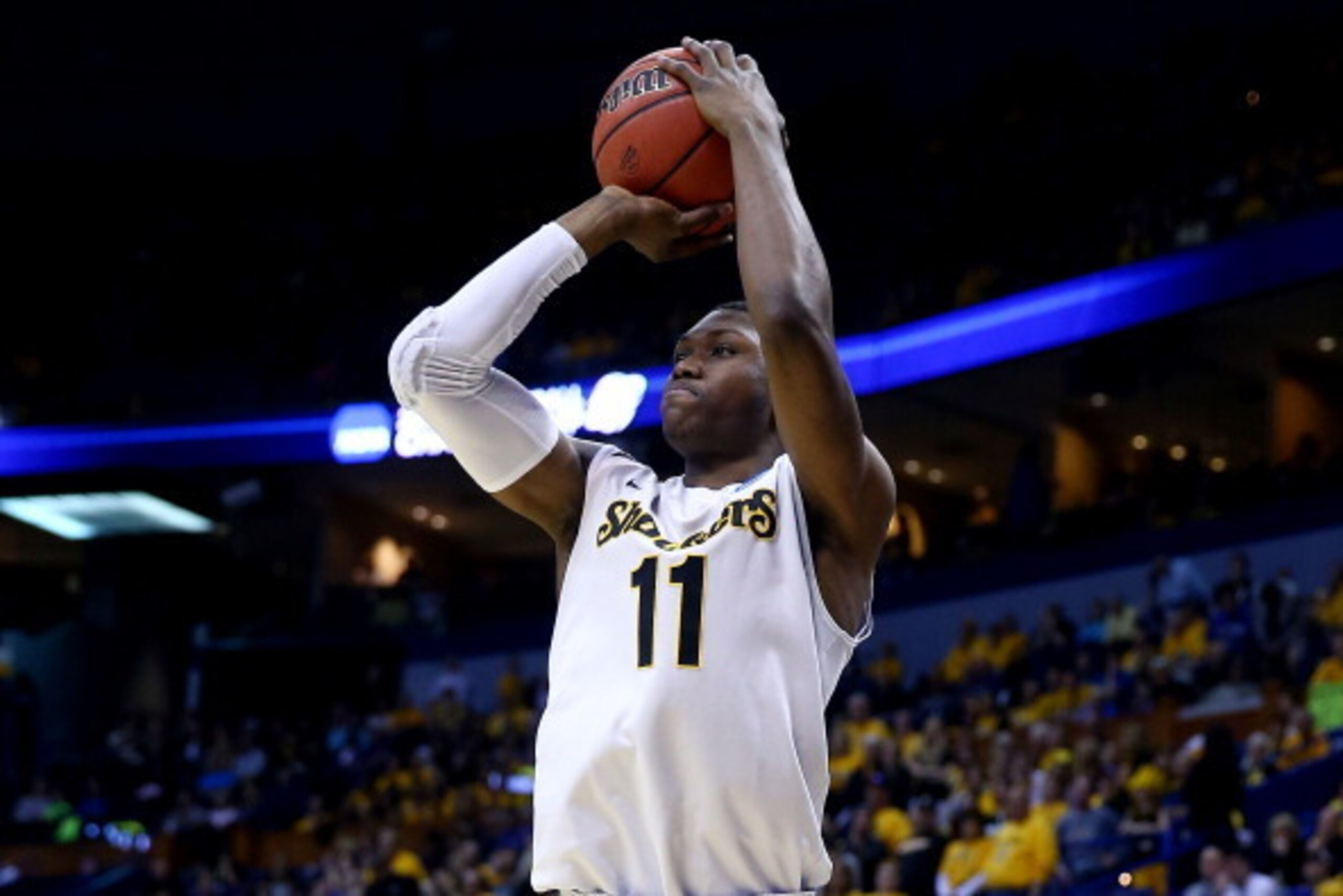 ST LOUIS, MO - MARCH 21:  Cleanthony Early #11 of the Wichita State Shockers takes a shot against the Cal Poly Mustangs during the second round of the 2014 NCAA Men's Basketball Tournament at the Scottrade Center on March 21, 2014 in St Louis, Missouri.  