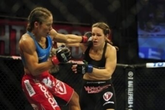 Nov 6, 2013; Fort Campbell, KY, USA; Liz Carmouche (red gloves) fights Alexis Davis (blue gloves) in the women's bantamweight bout during UFC Fight for the Troops at Fort Campbell. Mandatory Credit: Joshua Lindsey-USA TODAY Sports