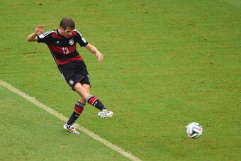 RECIFE, BRAZIL - JUNE 26:  Thomas Mueller of Germany shoots and scores his team's first goal during the 2014 FIFA World Cup Brazil group G match between the United States and Germany at Arena Pernambuco on June 26, 2014 in Recife, Brazil.  (Photo by Laure