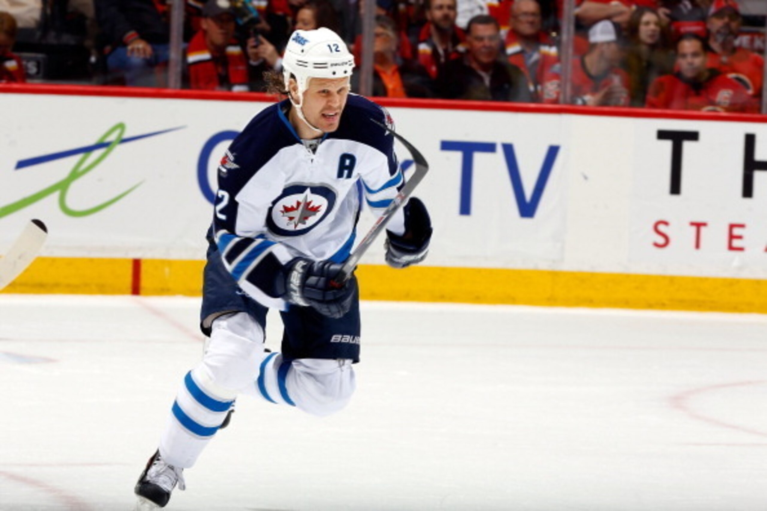 CALGARY, AB - APRIL 11: Olli Jokinen #12 of the Winnipeg Jets skates against the Calgary Flames at Scotiabank Saddledome on April 11, 2014 in Calgary, Alberta, Canada. The Jets won 4-3. (Photo by Gerry Thomas/NHLI via Getty Images)