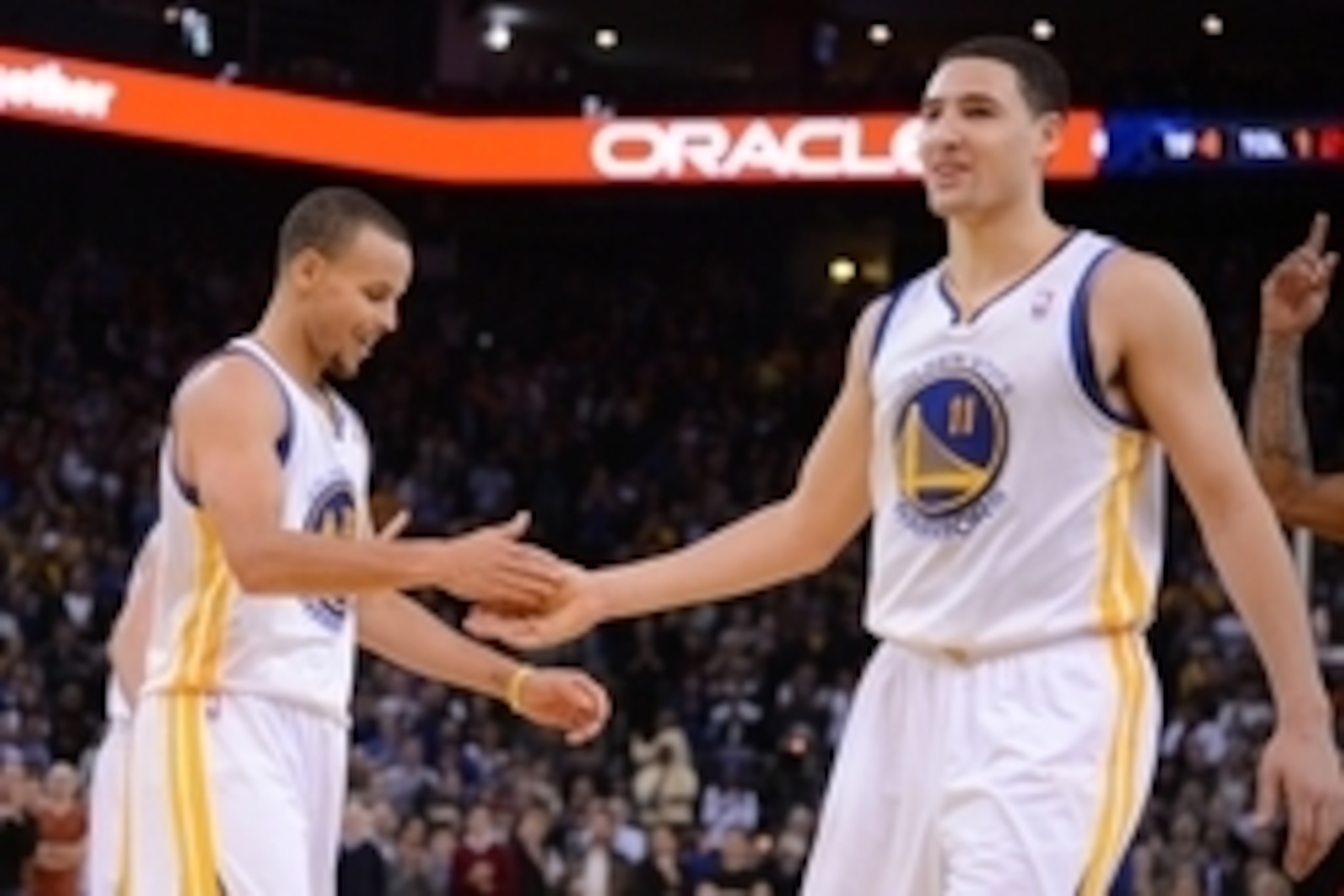 December 3, 2013; Oakland, CA, USA; Golden State Warriors point guard Stephen Curry (30, left) and shooting guard Klay Thompson (11) celebrate during the fourth quarter against the Toronto Raptors at Oracle Arena. The Warriors defeated the Raptors 112-103
