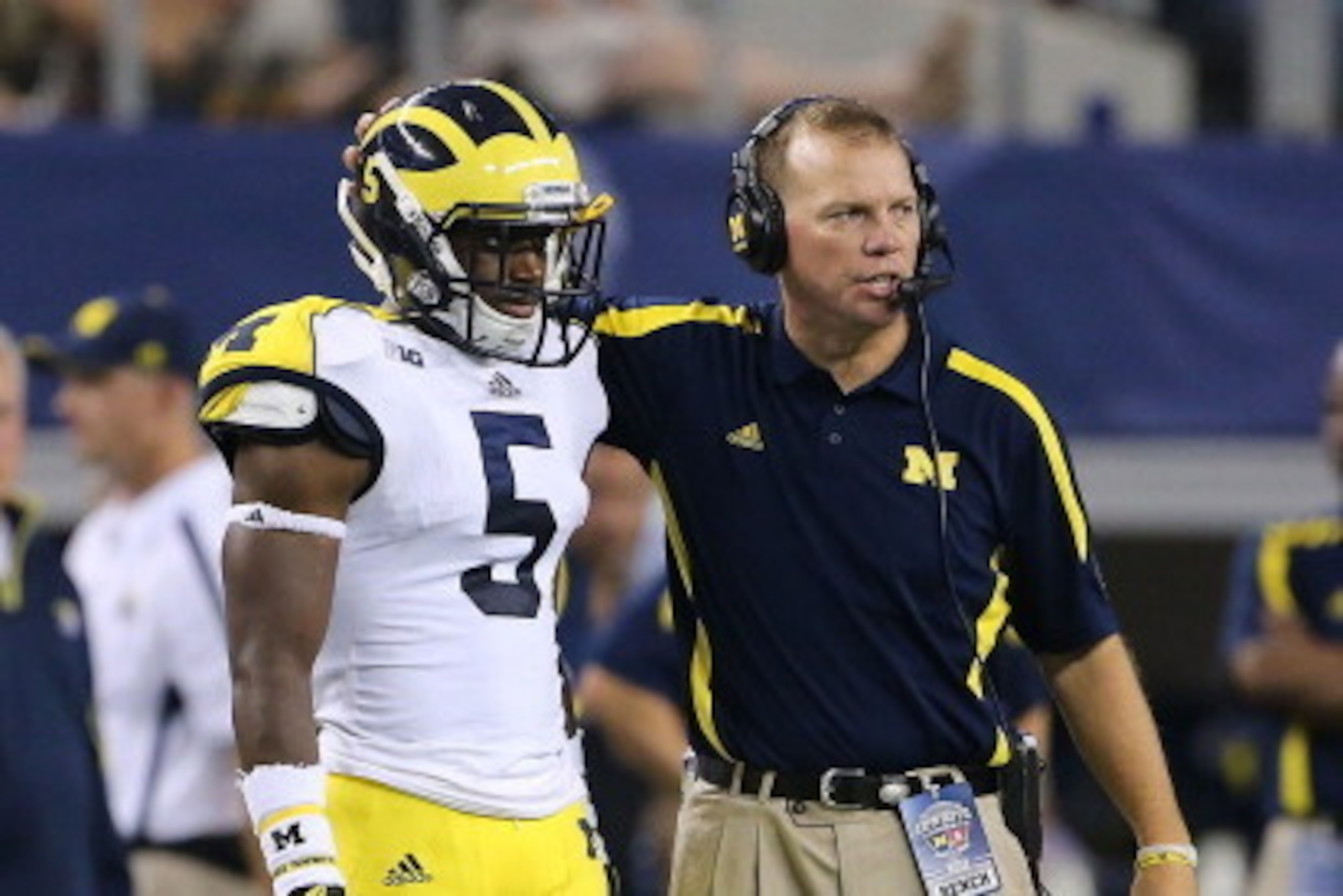 ARLINGTON, TX - SEPTEMBER 01: University of Michigan secondary coach Curt Mallory talks with Courtney Avery #5 during the game against the University of  Alabama at Cowboys Stadium on September 1, 2012 in Arlington, Texas. Alabama defeated Michigan 41-14.