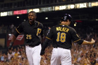 PITTSBURGH, PA - JULY 01:  Gregory Polanco #25 of the Pittsburgh Pirates and Neil Walker #18 celebrate after scoring on a two RBI double in the ninth inning against the Arizona Diamondbacks during the game at PNC Park on July 1, 2014 in Pittsburgh, Pennsy