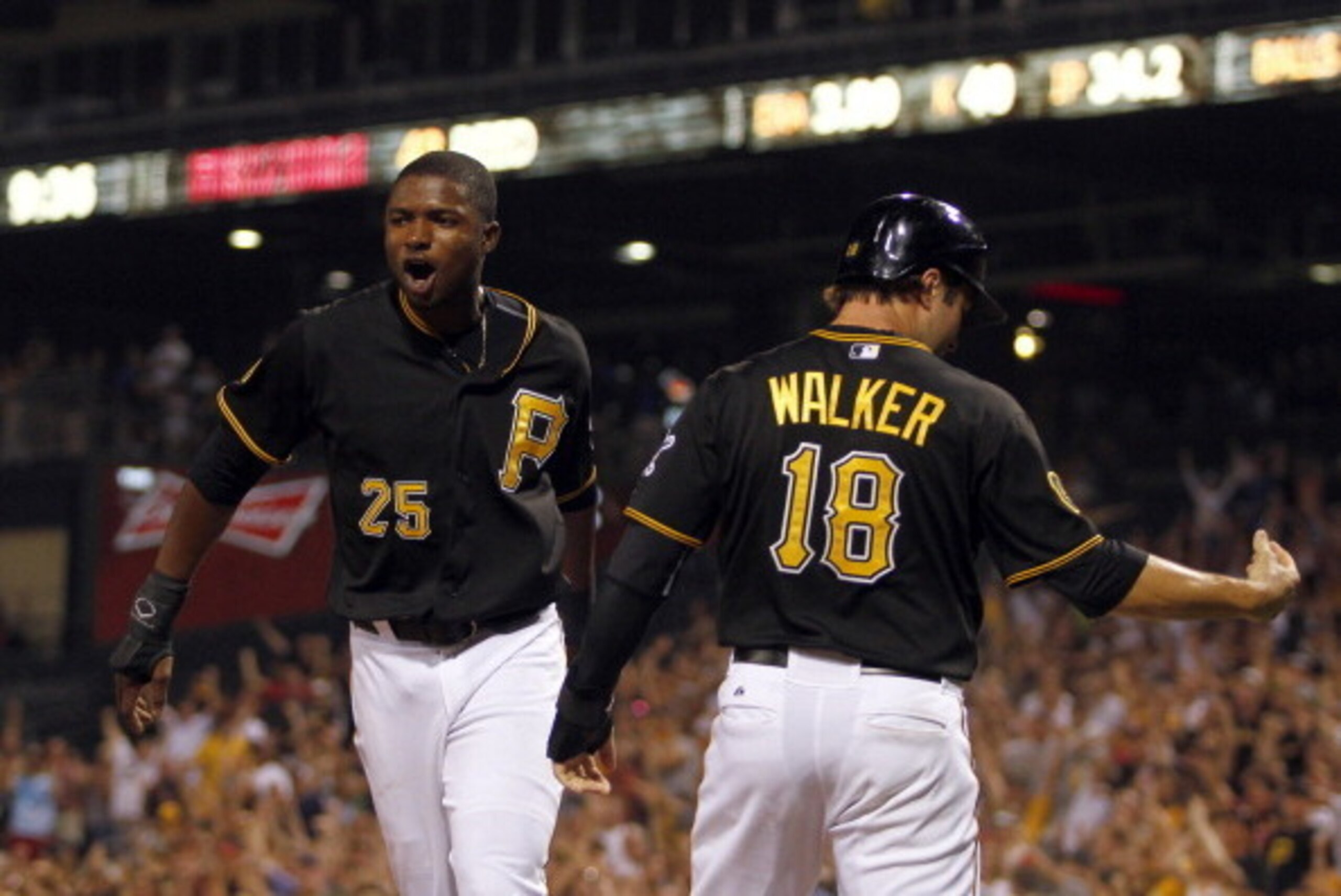PITTSBURGH, PA - JULY 01:  Gregory Polanco #25 of the Pittsburgh Pirates and Neil Walker #18 celebrate after scoring on a two RBI double in the ninth inning against the Arizona Diamondbacks during the game at PNC Park on July 1, 2014 in Pittsburgh, Pennsy