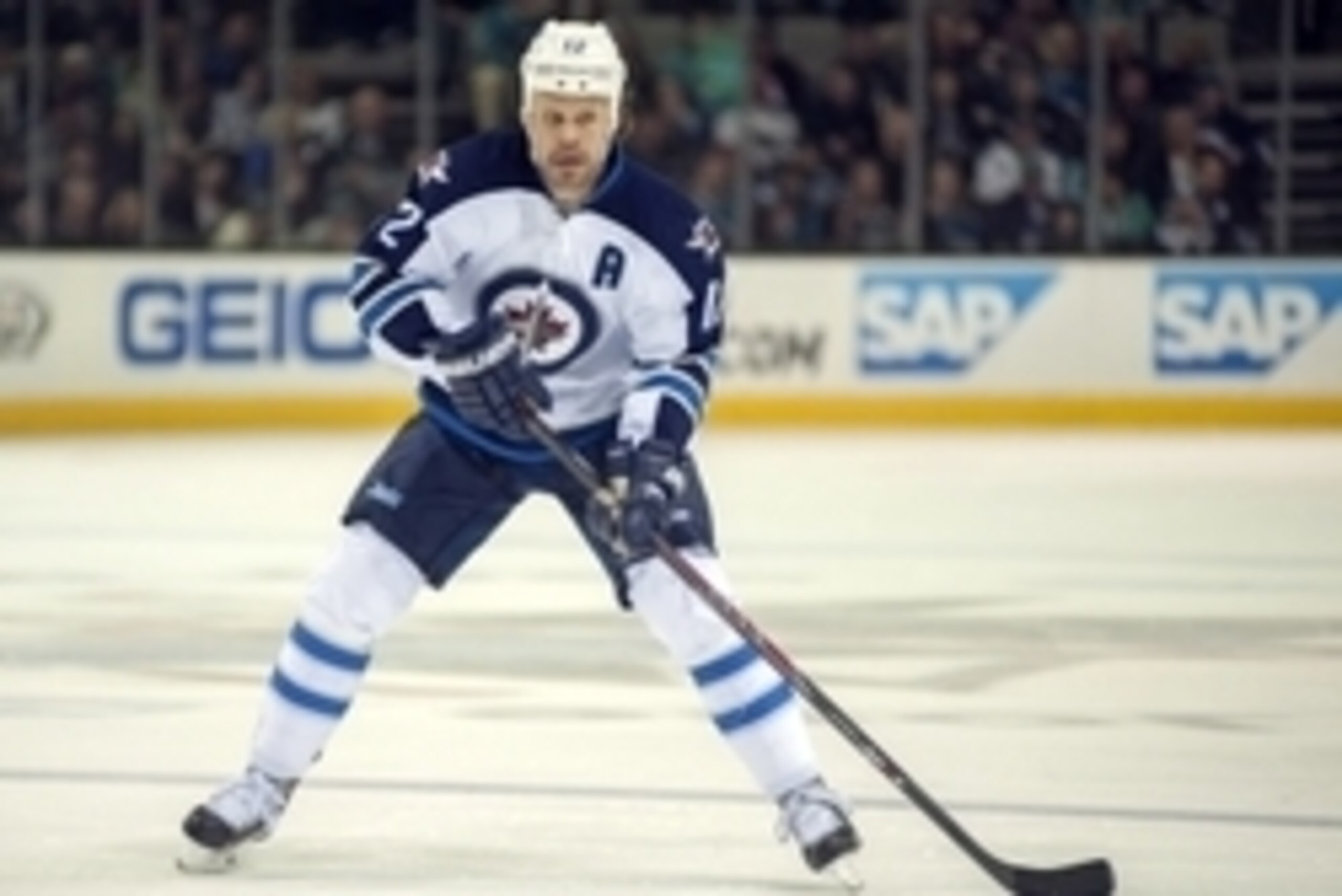 Mar 27, 2014; San Jose, CA, USA; Winnipeg Jets center Olli Jokinen (12) controls the puck against the San Jose Sharks during the second period at SAP Center at San Jose. Mandatory Credit: Ed Szczepanski-USA TODAY Sports