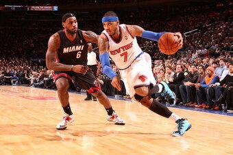 NEW YORK, NY - JANUARY 9: Carmelo Anthony #7 of the New York Knicks drives against LeBron James #6 of the Miami Heat during a game at Madison Square Garden in New York City on January 9, 2014.  NOTE TO USER: User expressly acknowledges and agrees that, by