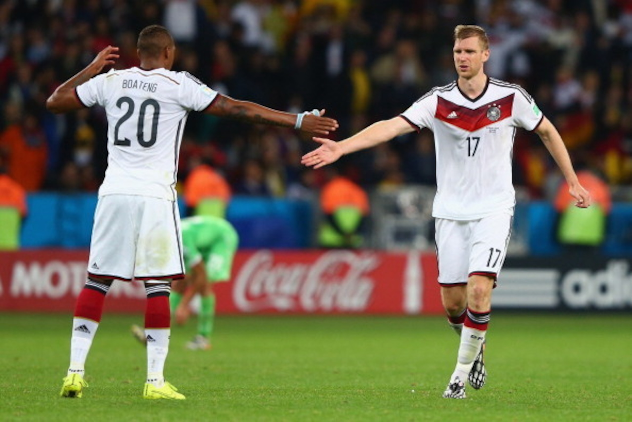 PORTO ALEGRE, BRAZIL - JUNE 30:  Jerome Boateng and Per Mertesacker of Germany celebrate their team's second goal in extra time during the 2014 FIFA World Cup Brazil Round of 16 match between Germany and Algeria at Estadio Beira-Rio on June 30, 2014 in Po