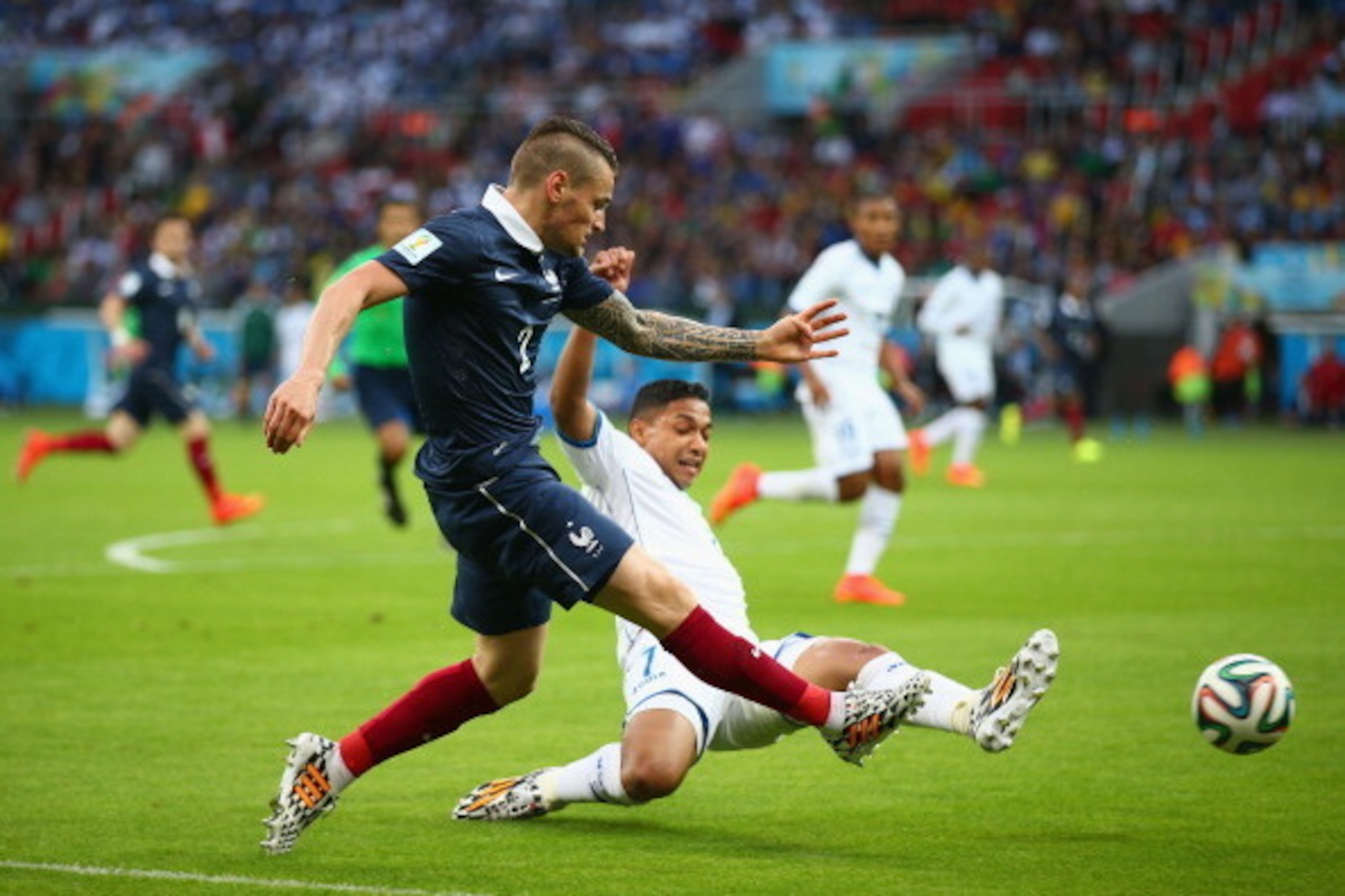 PORTO ALEGRE, BRAZIL - JUNE 15: Mathieu Debuchy of France and Emilio Izaguirre of Honduras battle for the ball during the 2014 FIFA World Cup Brazil Group E match between France and Honduras at Estadio Beira-Rio on June 15, 2014 in Porto Alegre, Brazil. PORTO ALEGRE, BRAZIL - JUNE 15: Mathieu Debuchy of France and Emilio Izaguirre of Honduras battle for the ball during the 2014 FIFA World Cup Brazil Group E match between France and Honduras at Estadio Beira-Rio on June 15, 2014 in Porto Alegre, Brazil.