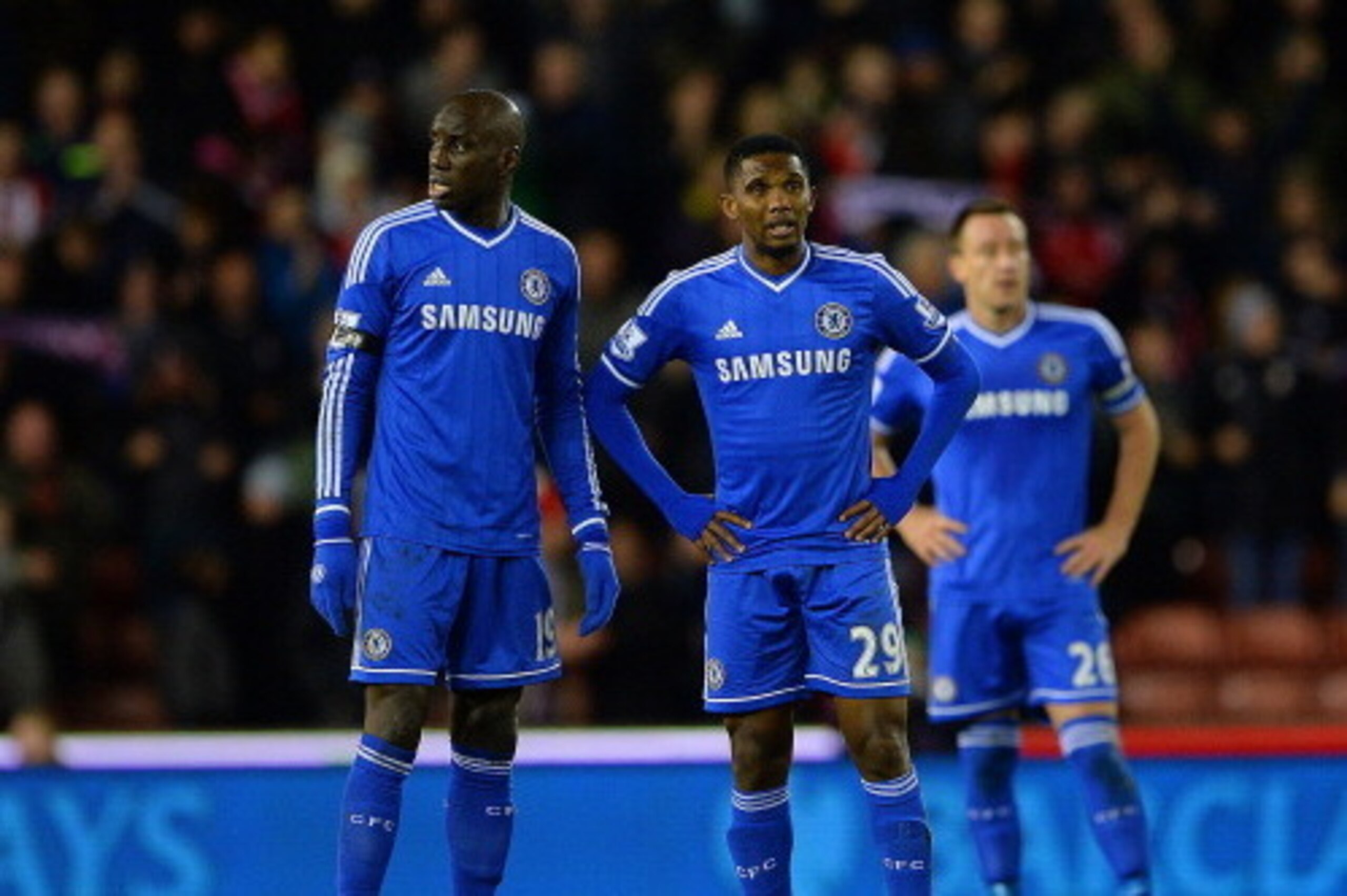 STOKE ON TRENT, ENGLAND - DECEMBER 07:  Dejected Chelsea players Demba Ba, Samuel Eto'o and John Terry react after conceding a third goal  during the Barclays Premier League match between Stoke City and Chelsea at Britannia Stadium on December 7, 2013 in 