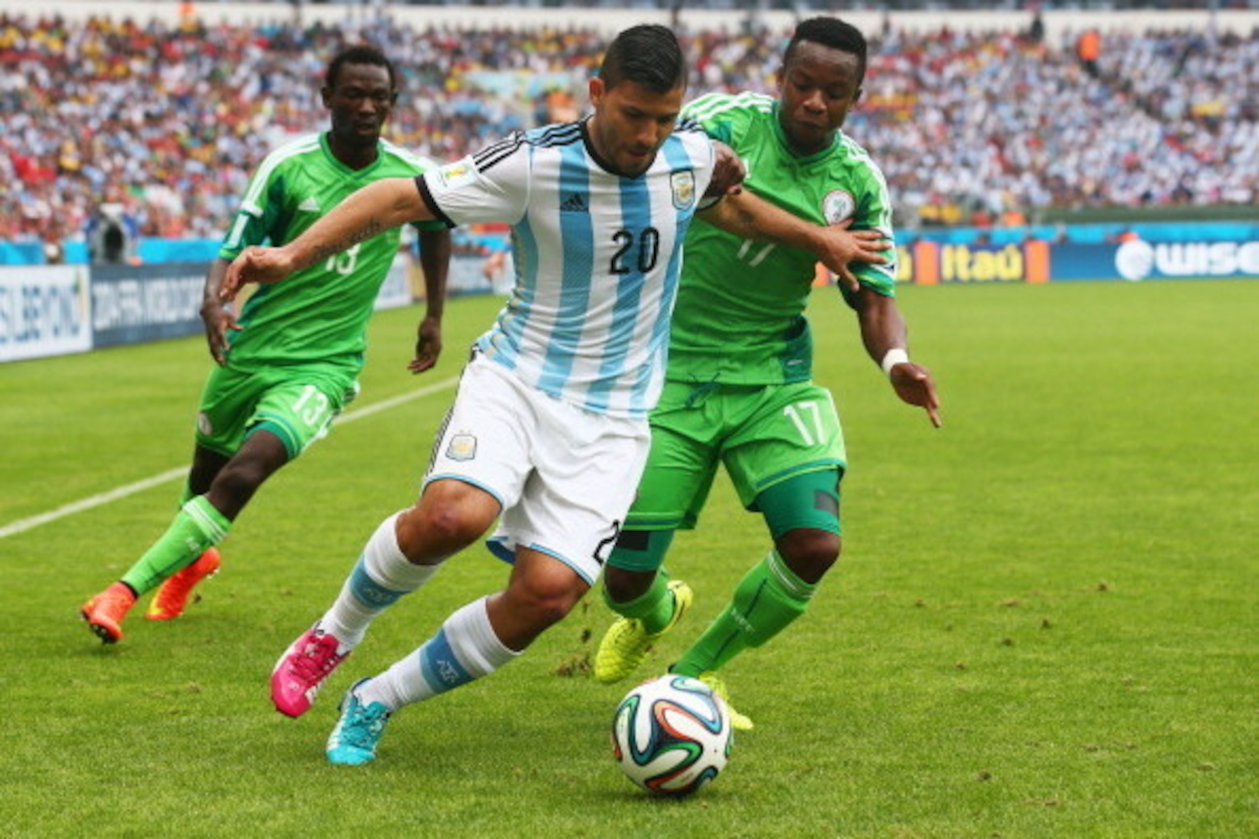 PORTO ALEGRE, BRAZIL - JUNE 25: Sergio Aguero of Argentina controls the ball against Ogenyi Onazi of Nigeria during the 2014 FIFA World Cup Brazil Group F match between Nigeria and Argentina at Estadio Beira-Rio on June 25, 2014 in Porto Alegre, Brazil.  