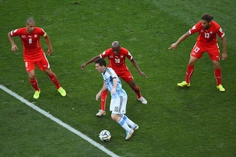 SAO PAULO, BRAZIL - JULY 01:  Lionel Messi of Argentina takes on Gokhan Inler (L), Gelson Fernandes and Ricardo Rodriguez of Switzerlandduring the 2014 FIFA World Cup Brazil Round of 16 match between Argentina and Switzerland at Arena de Sao Paulo on July